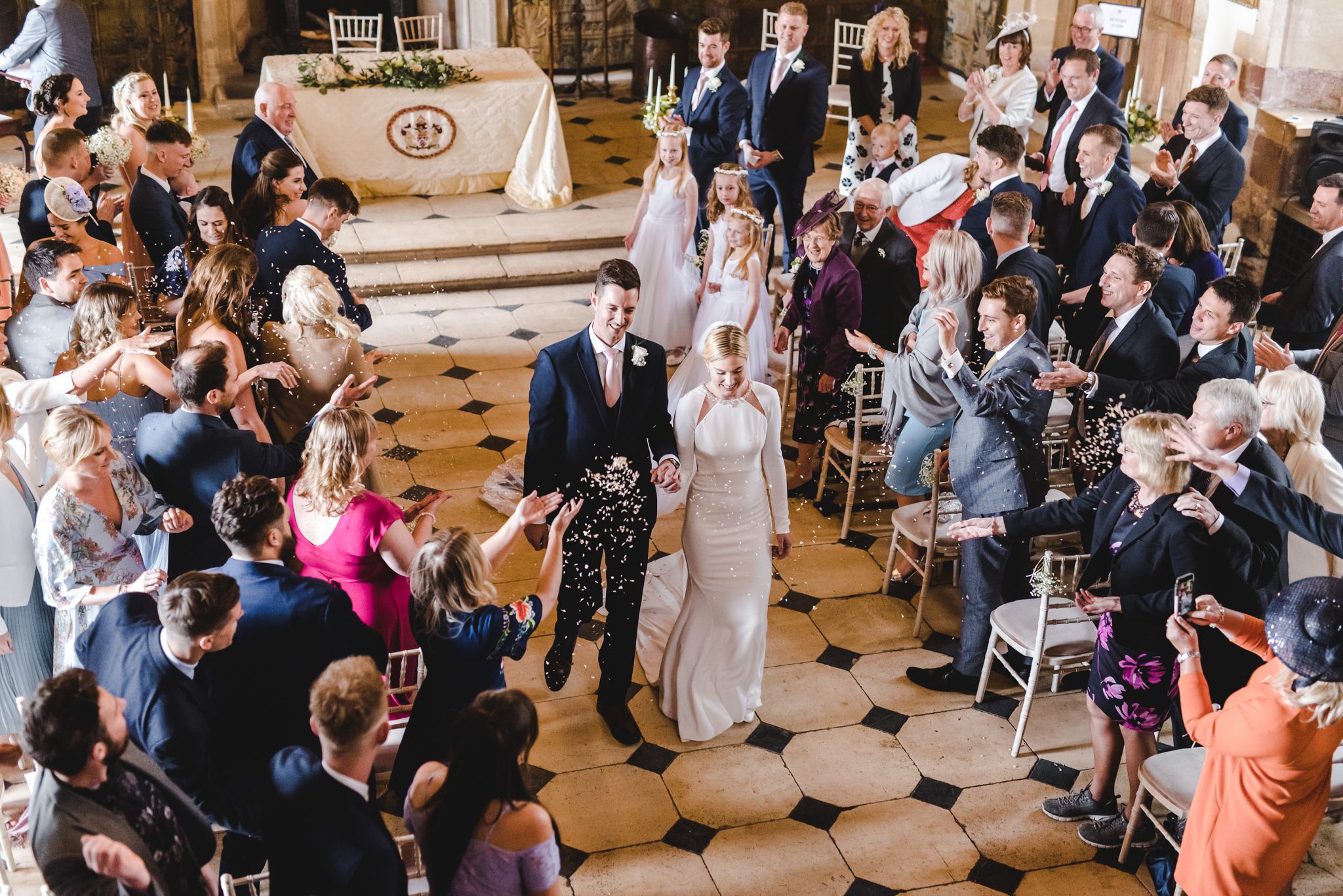 Confetti during the walk back down the aisle at Berkeley Castle in Glos