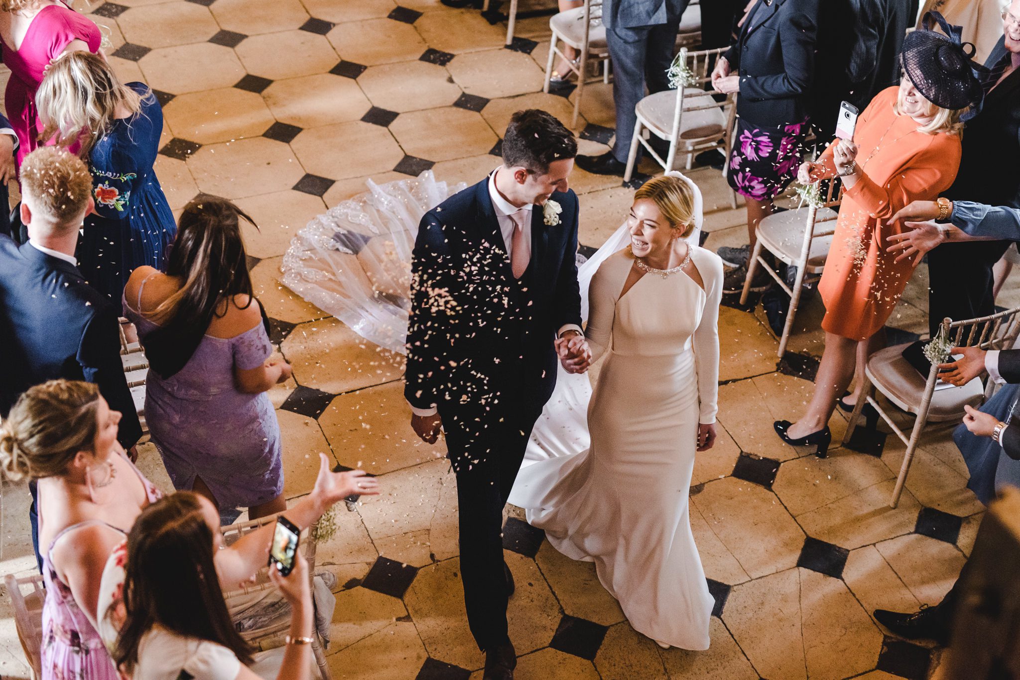 Confetti during the walk back down the aisle at Berkeley Castle in Glos