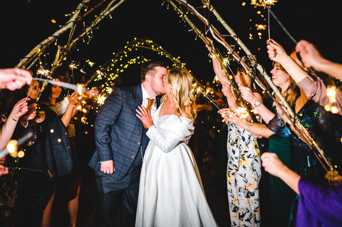 a sparkler aisle at a wedding at wick farm barn near bath