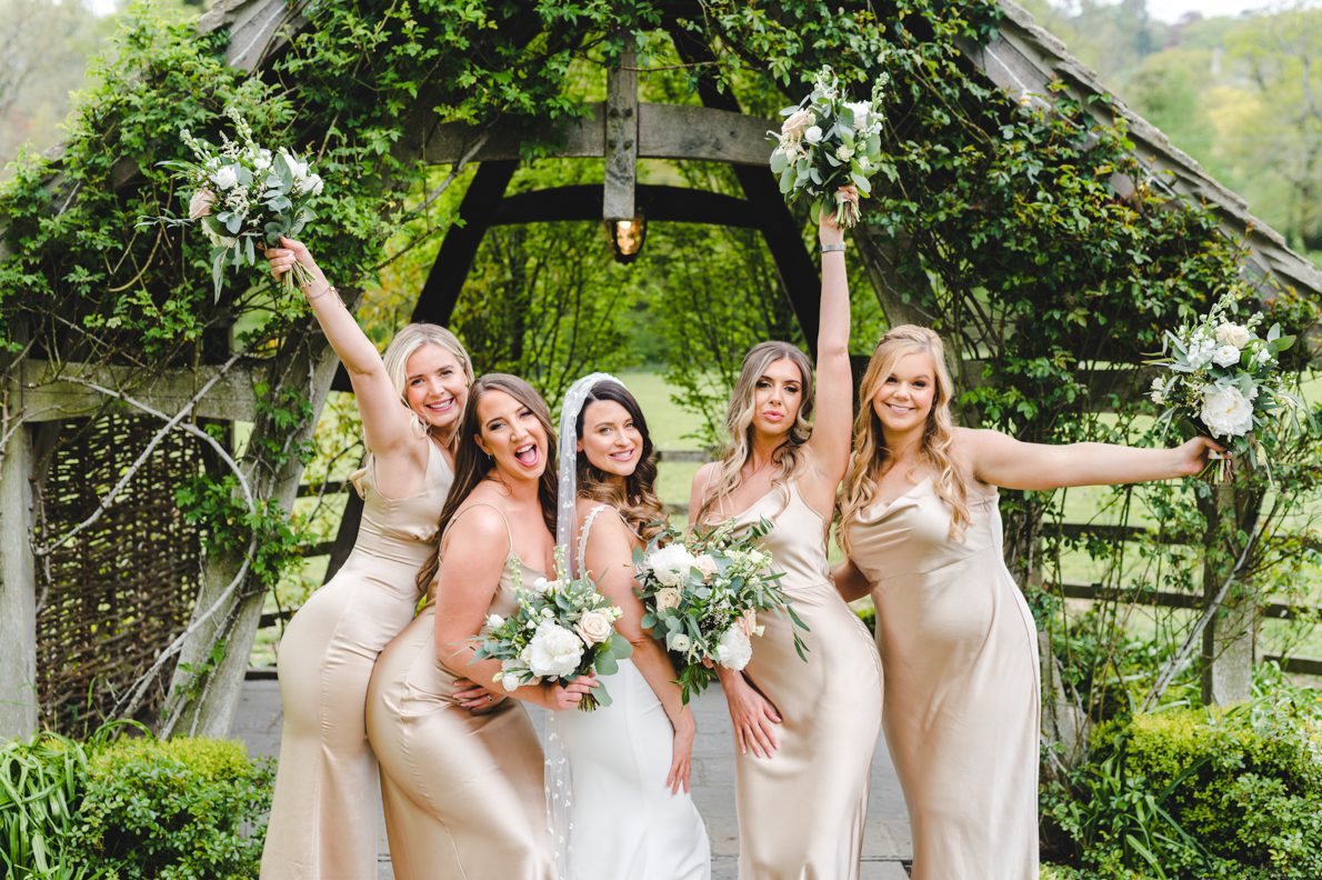 bride squad in front of the arbor at hyde house