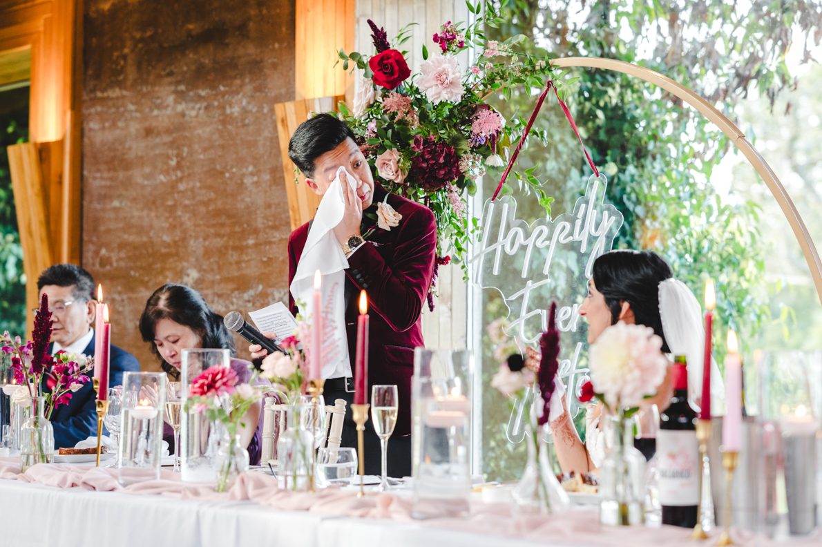 A groom wiping his eyes during his speech at Emore Court