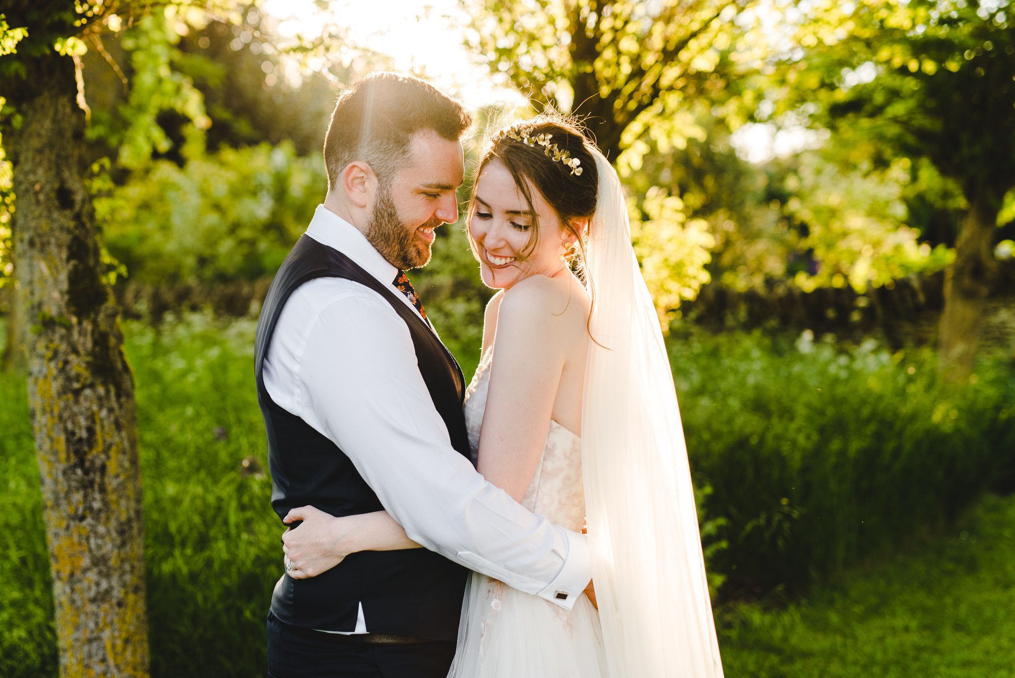 A couple at sunset at their Oxleaze Barn wedding