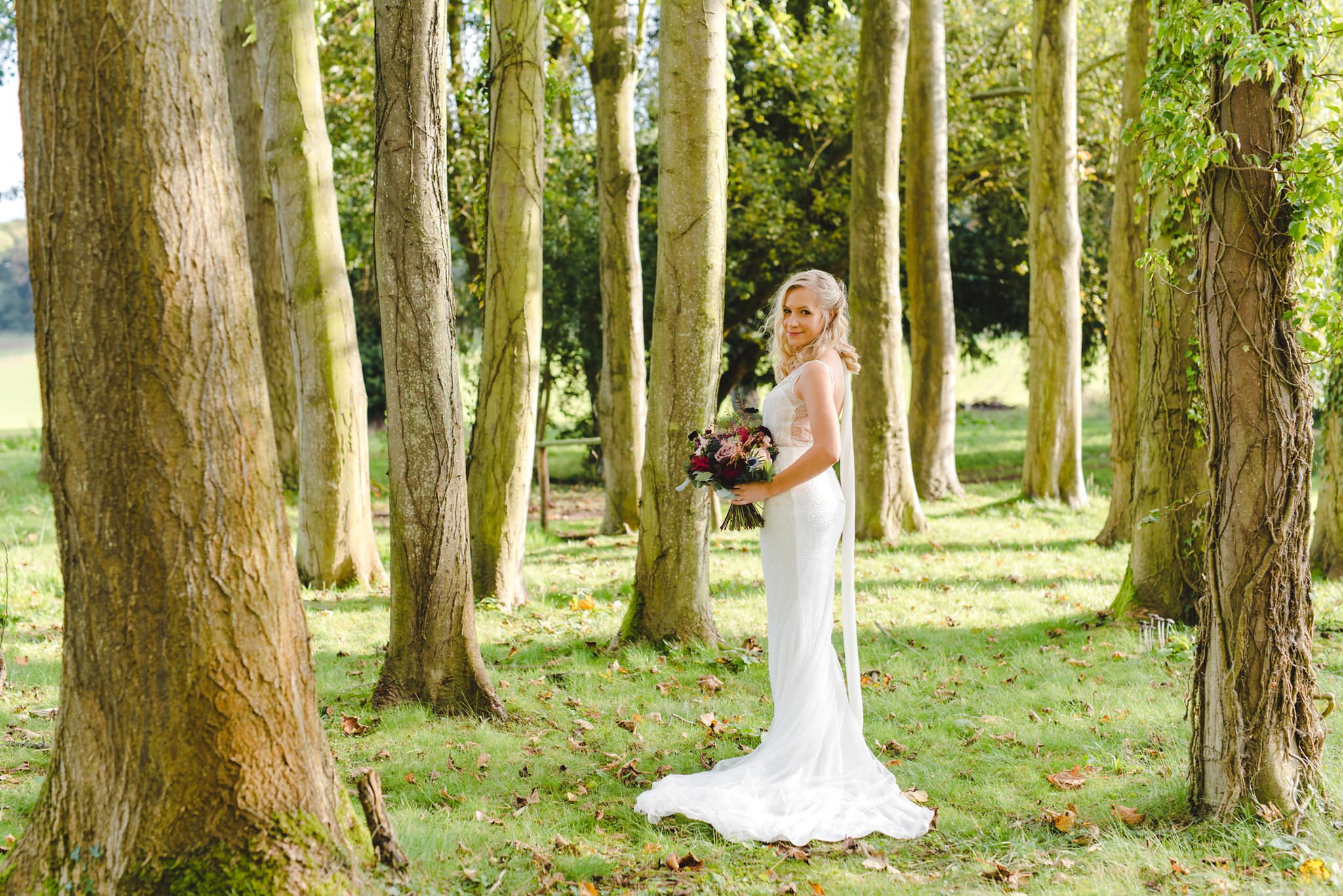 A bride standing in the gardens at Brinsop Court