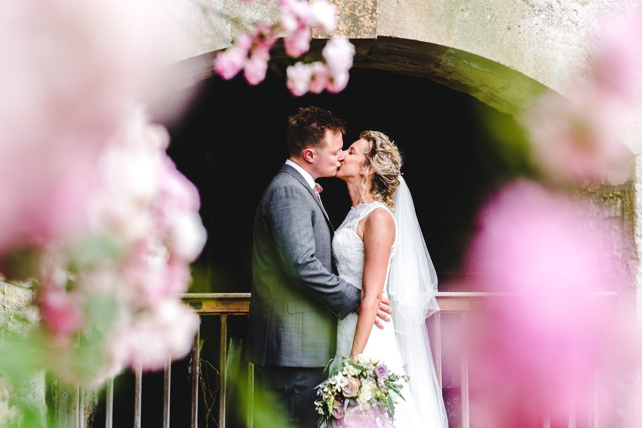 Bride and groom under a flower arch