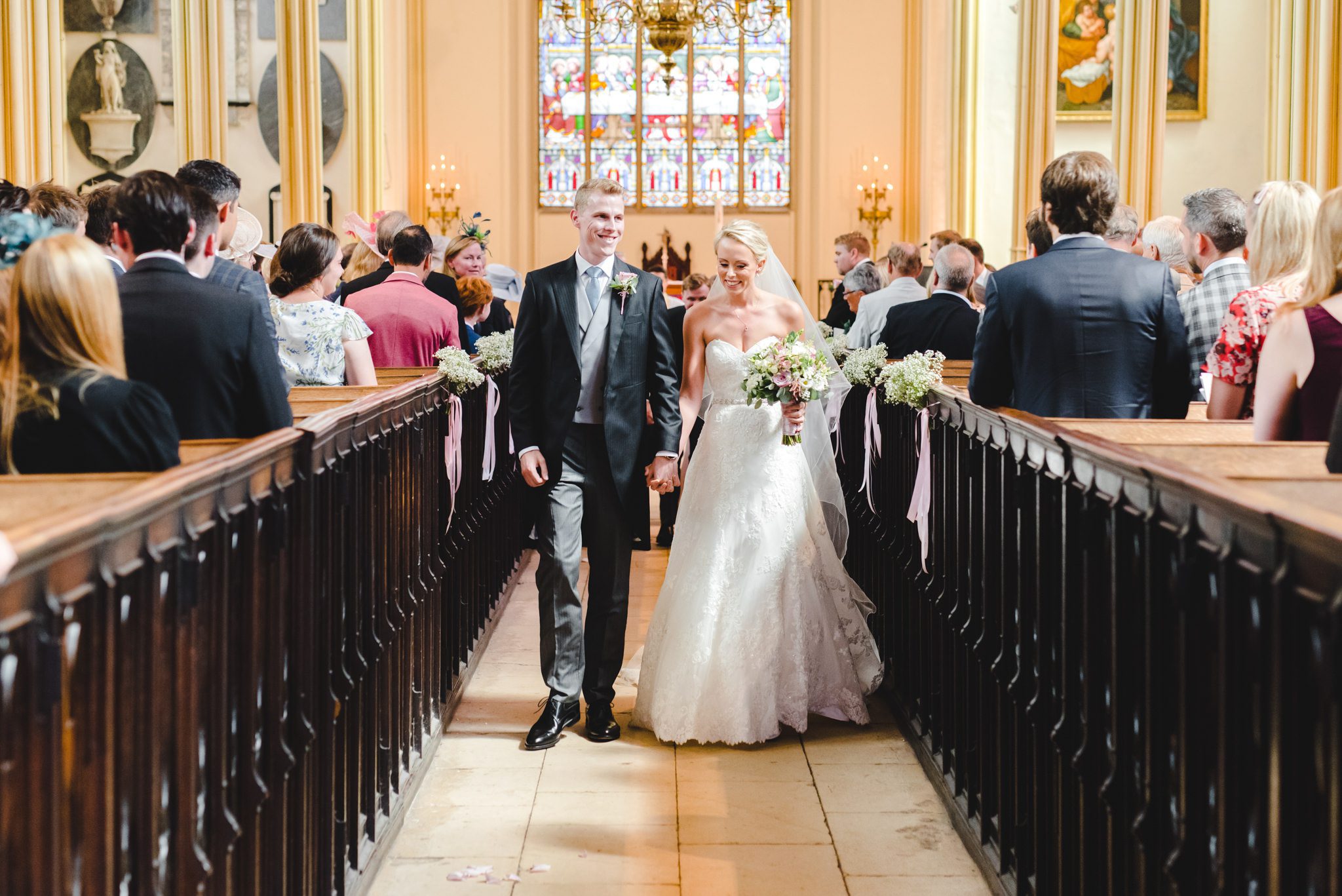 A couple leaving their church ceremony in Tetbury