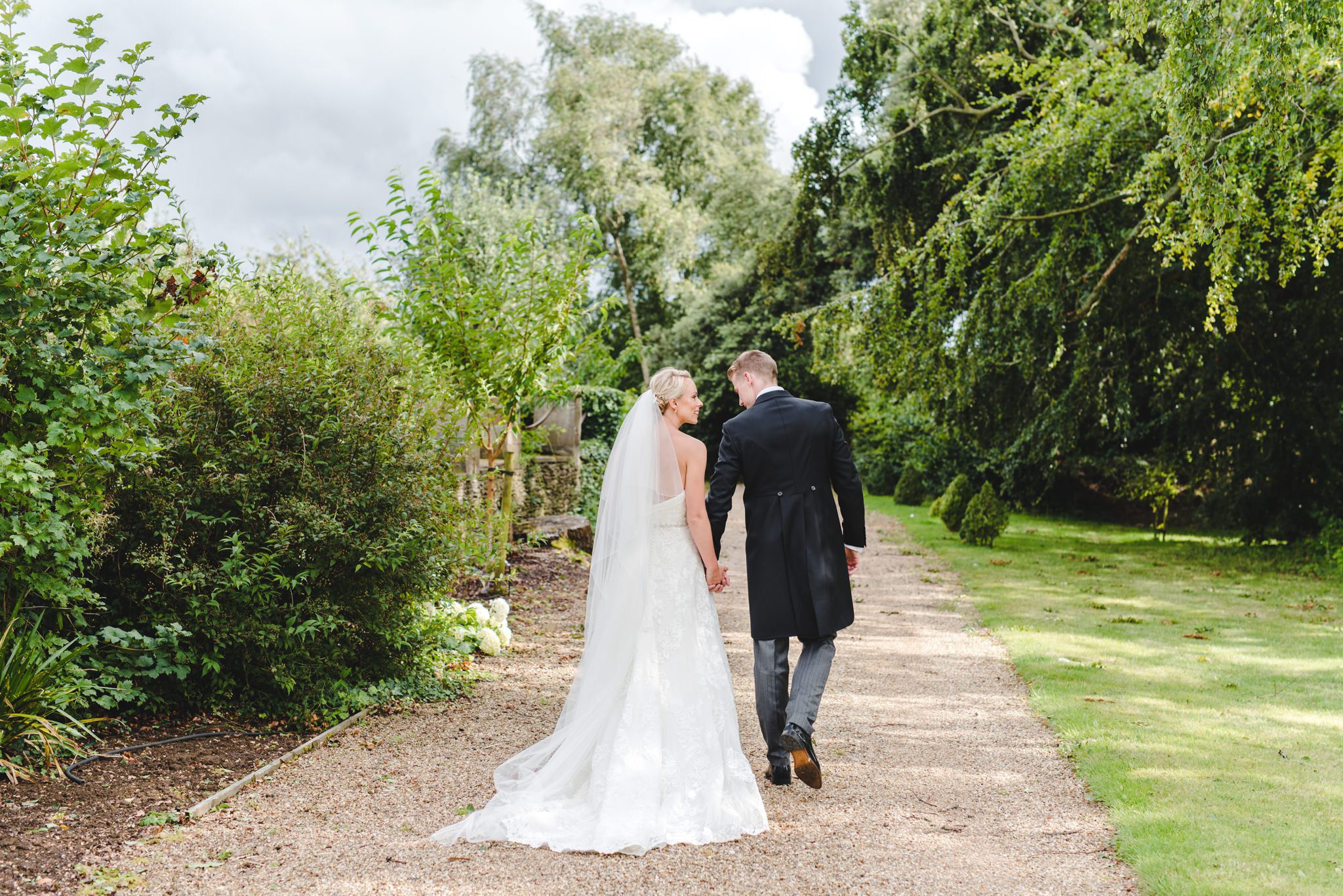 A couple walking away from the camera at a wedding