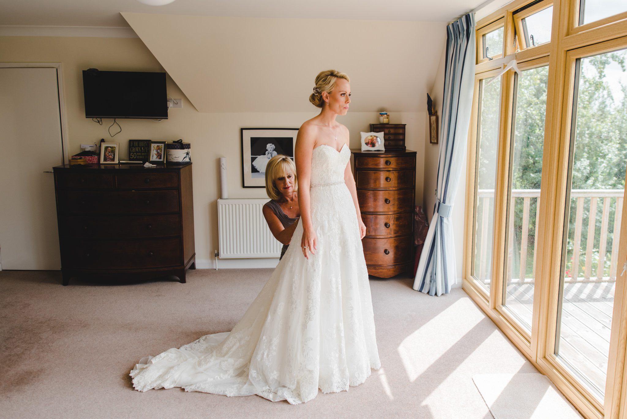 A bride putting on her dress