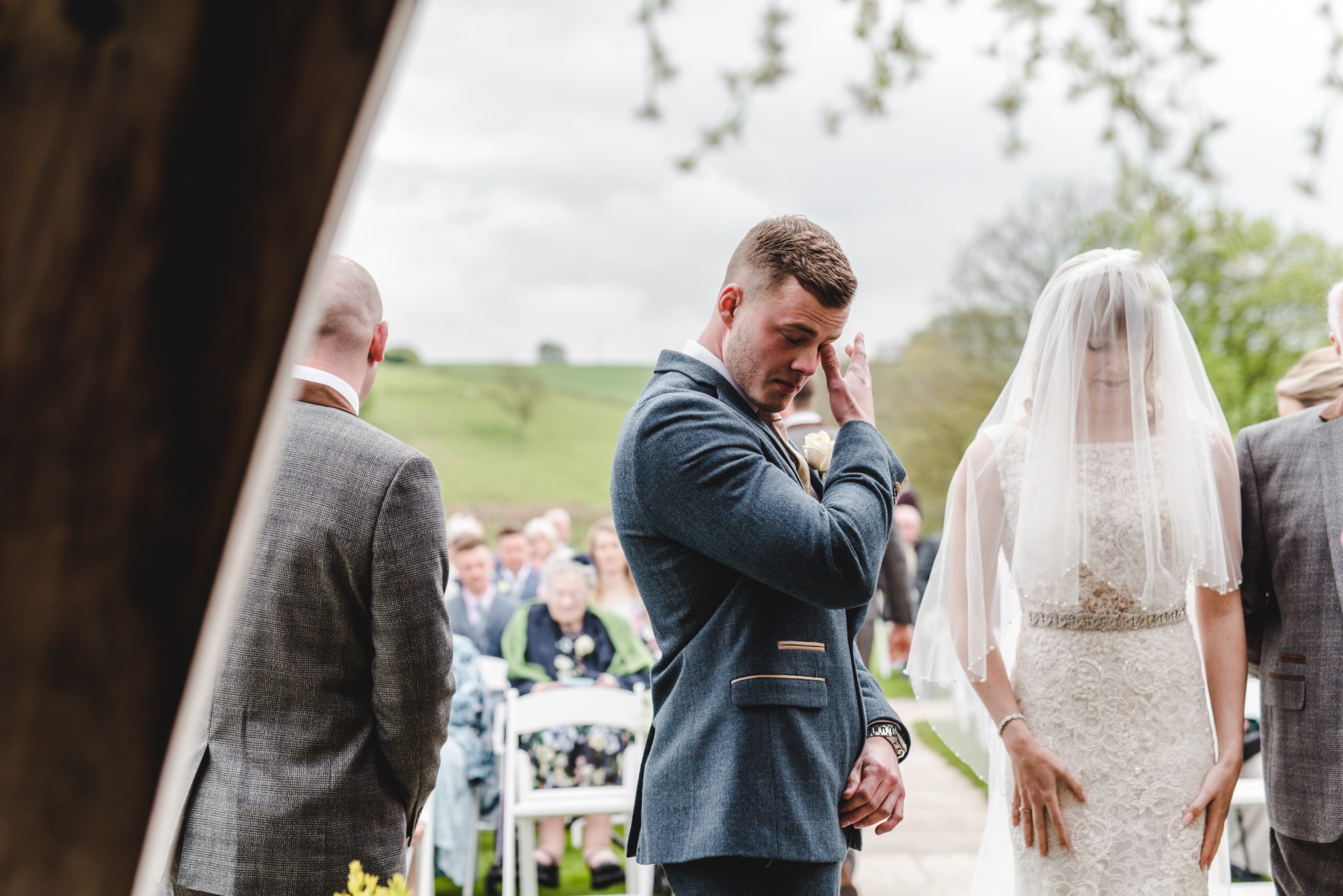 Groom wiping away a tear