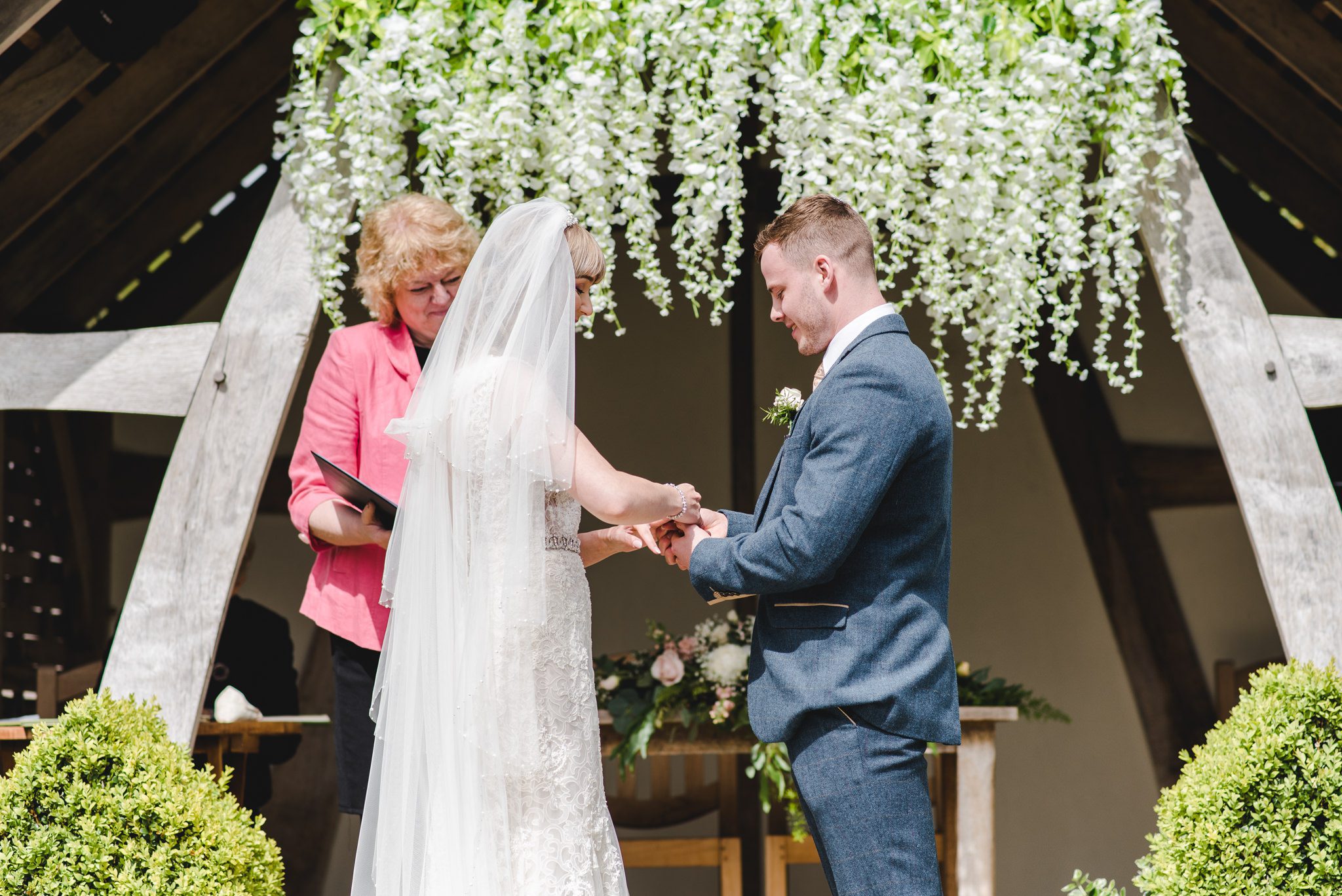 Exchanging rings outside the Linhay at Kingscote Barn