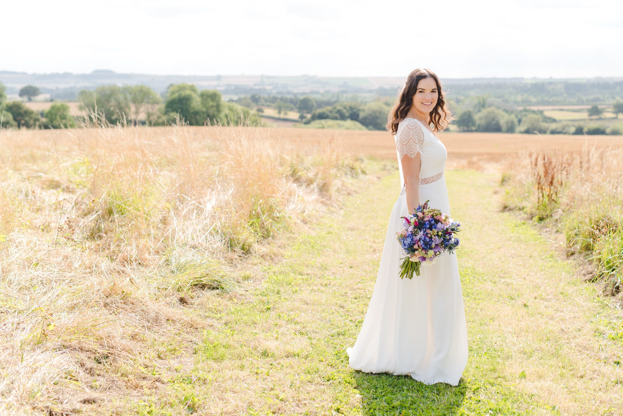 A bride standing in a field