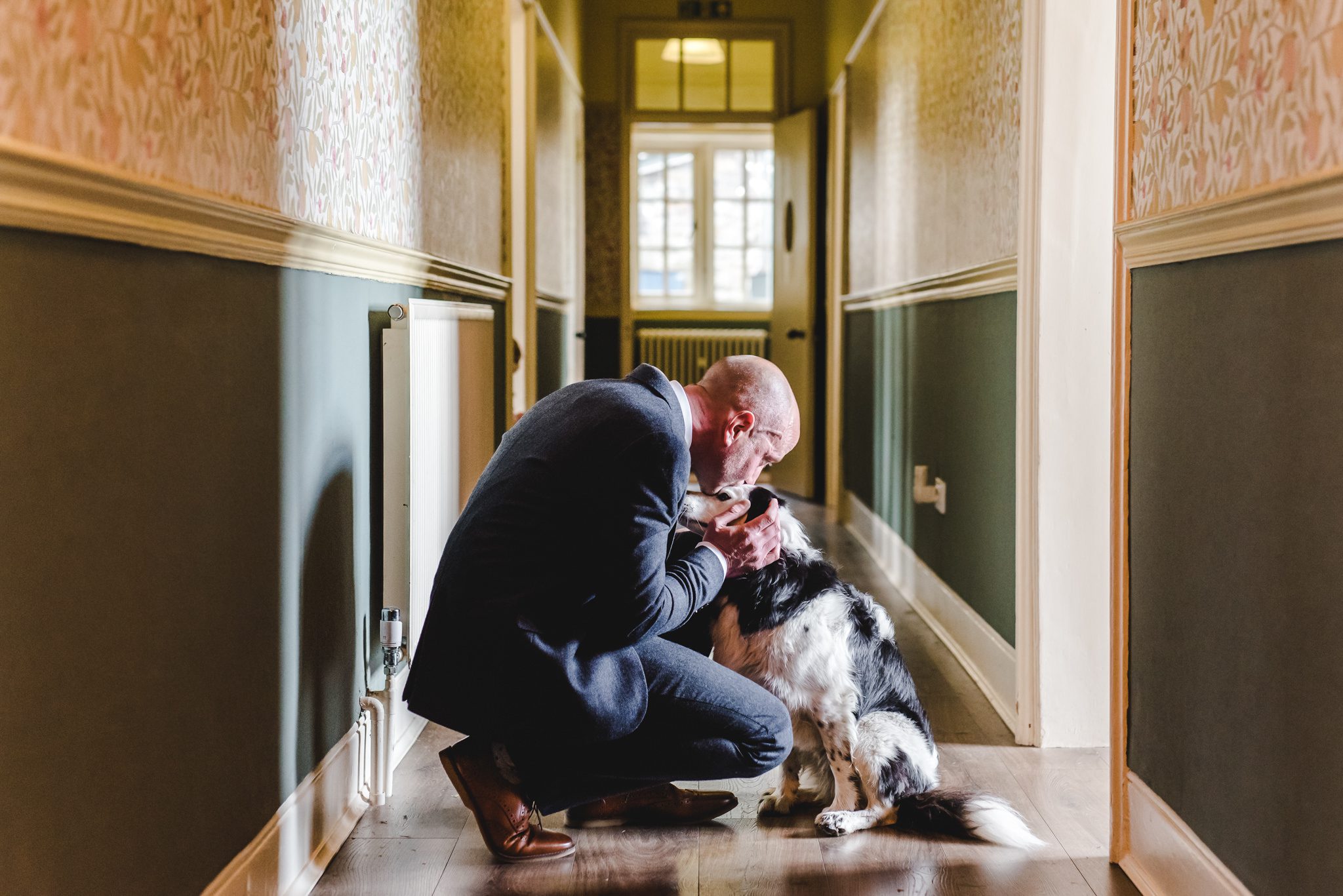 A man with his dog at a wedding