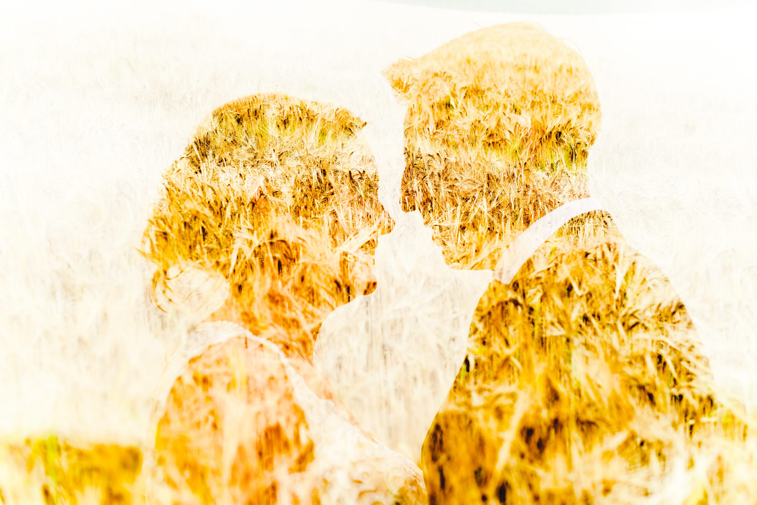 A double exposure of a couple in a cornfield