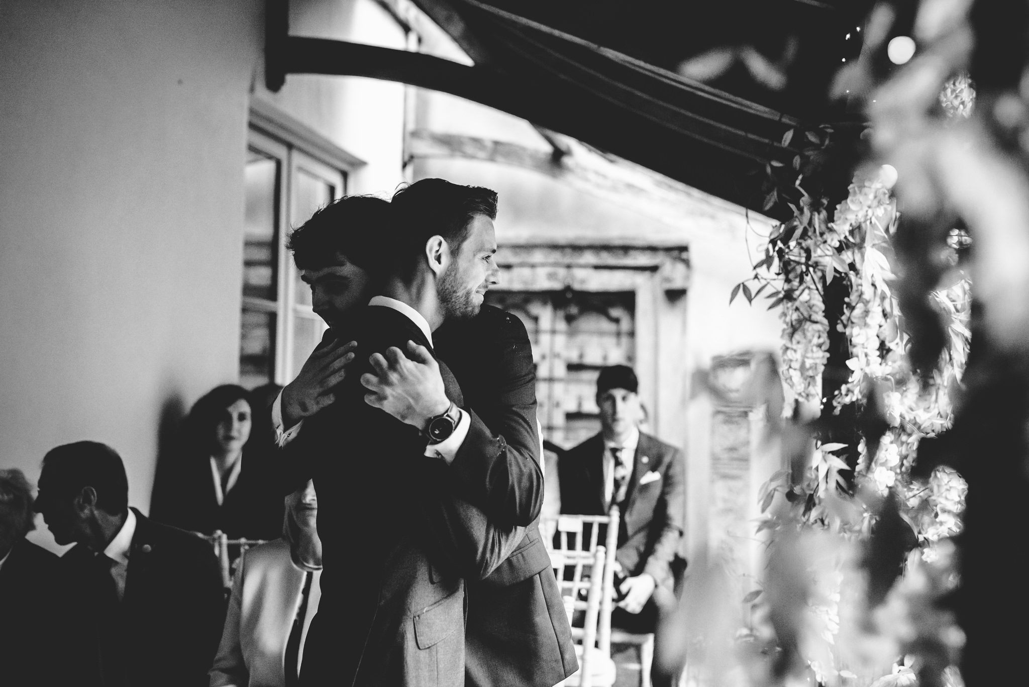 A groom and his best man hugging beofre the wedding ceremony