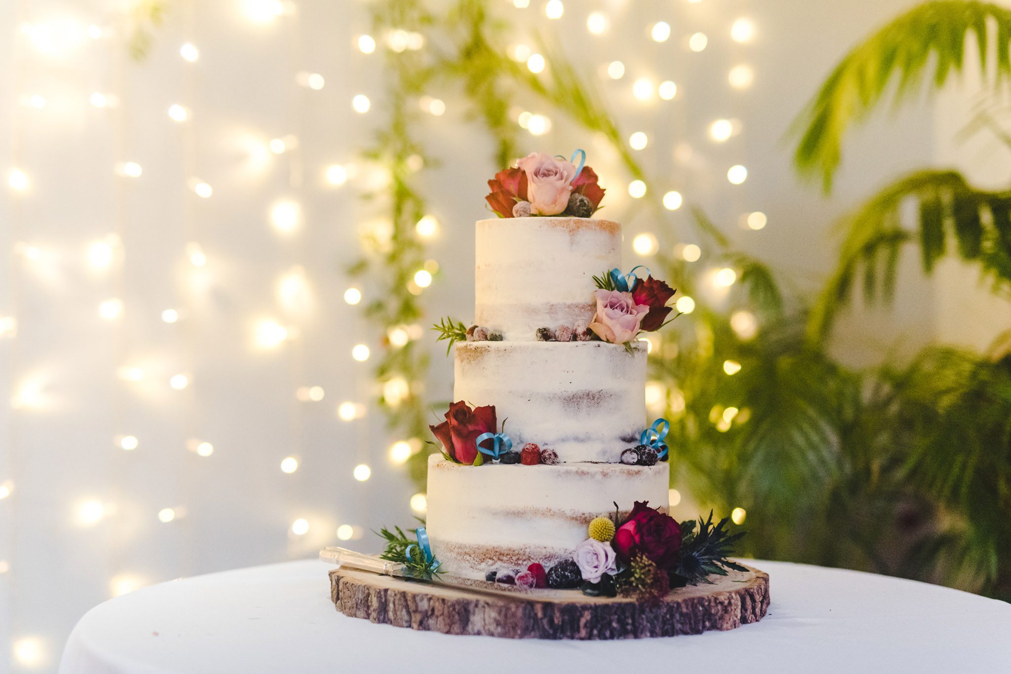 Wedding cake on a table with fairy lights