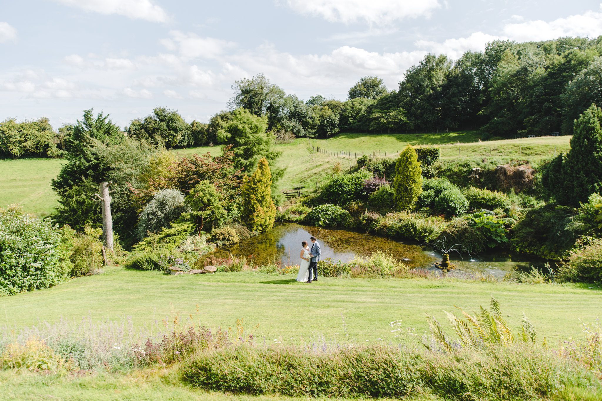 A bride and groom in the gardens at Upcote
