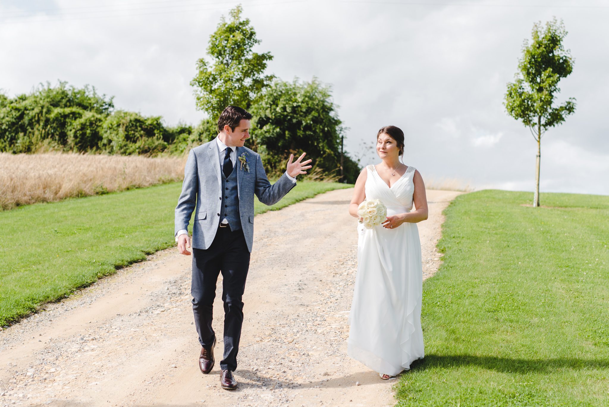 A groom at upcote barn showing his wife his wedding ring