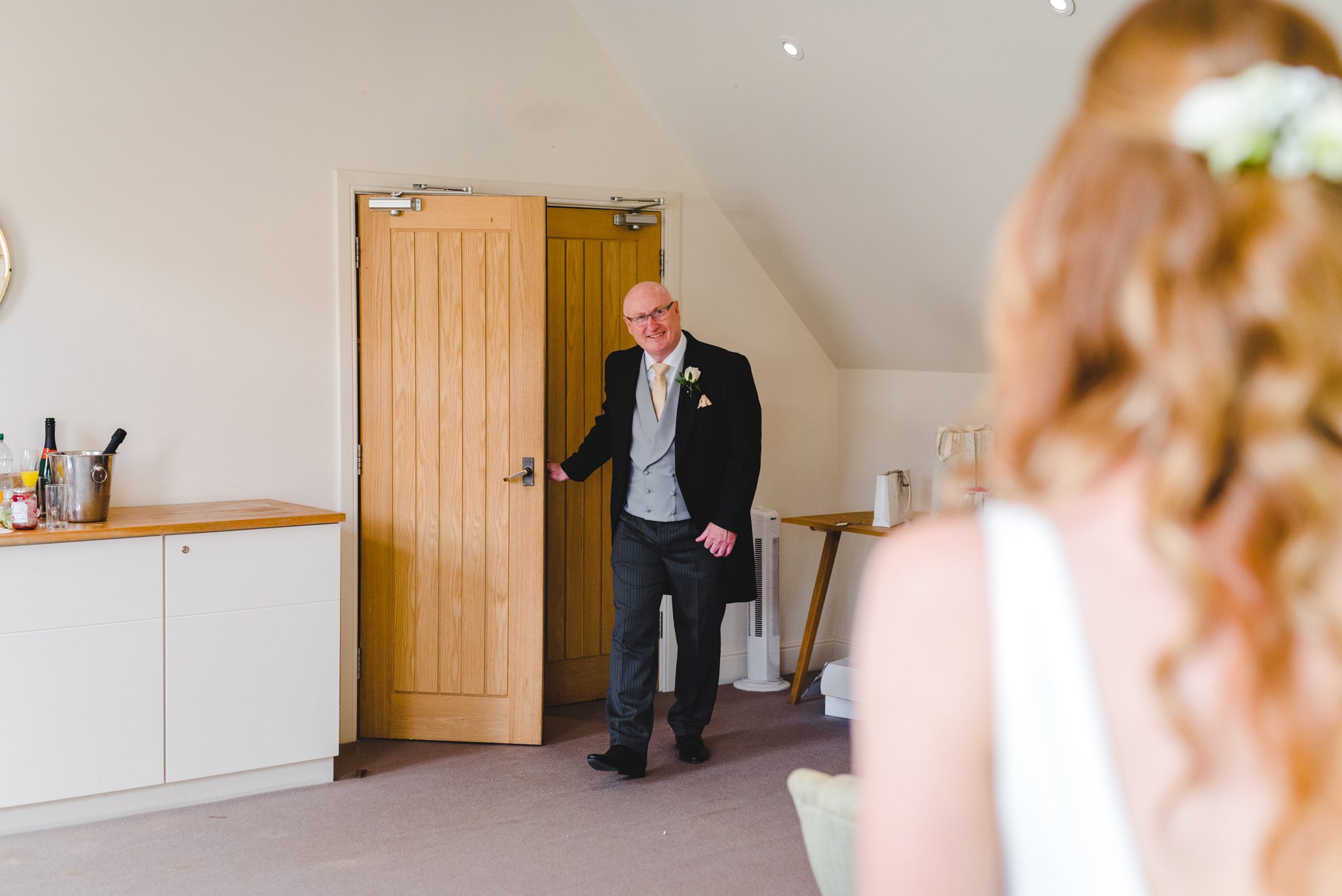 A dad seeing his daughter in her wedding dress for the first time