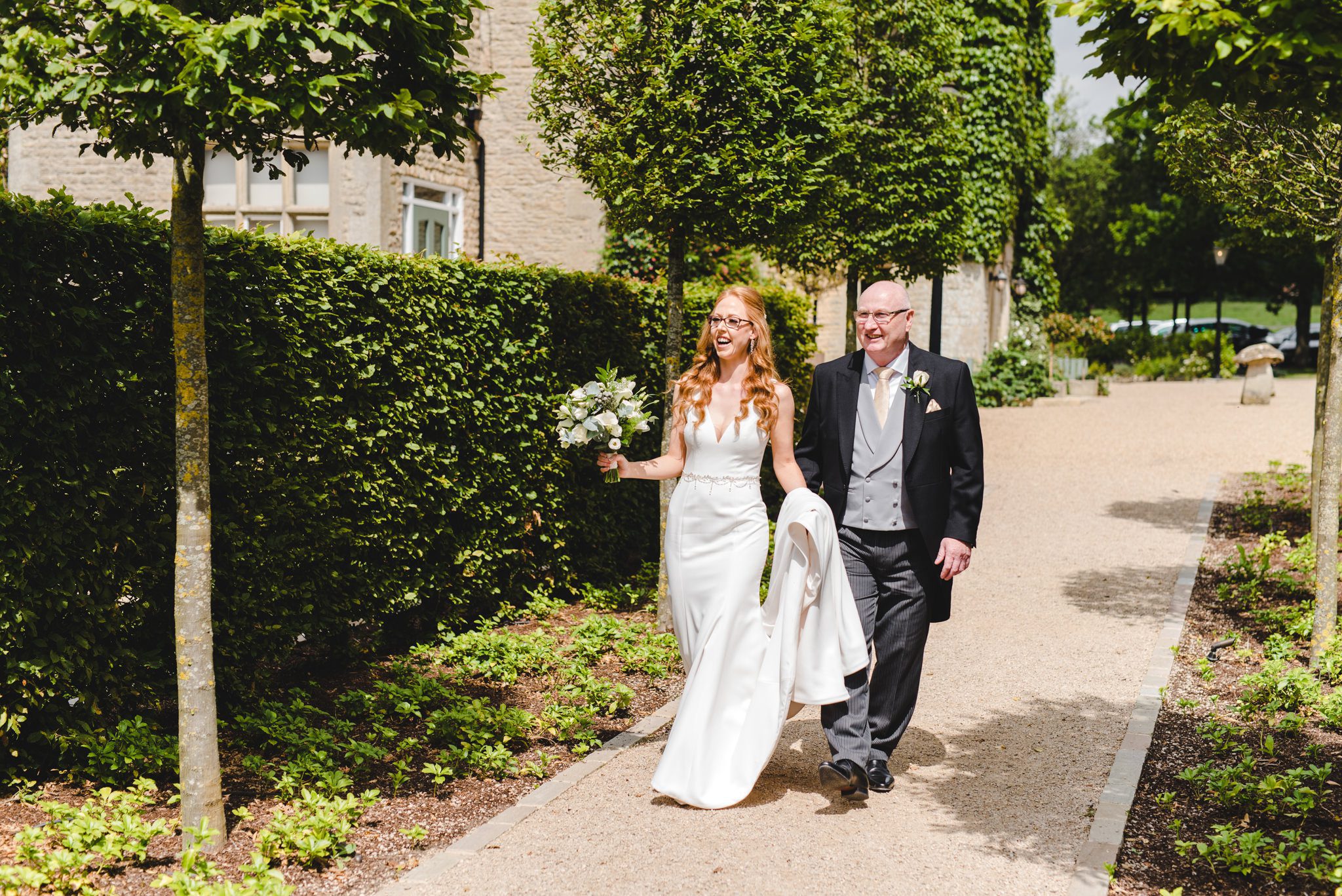 A bride walking to her wedidng ceremony with her dad