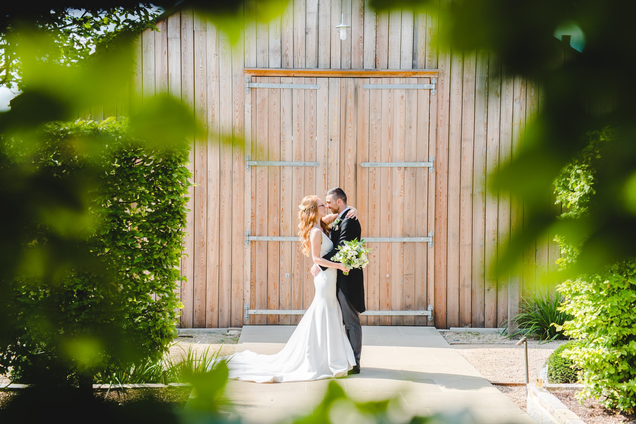 A wedding couple standing in front of The Grange at Hyde House