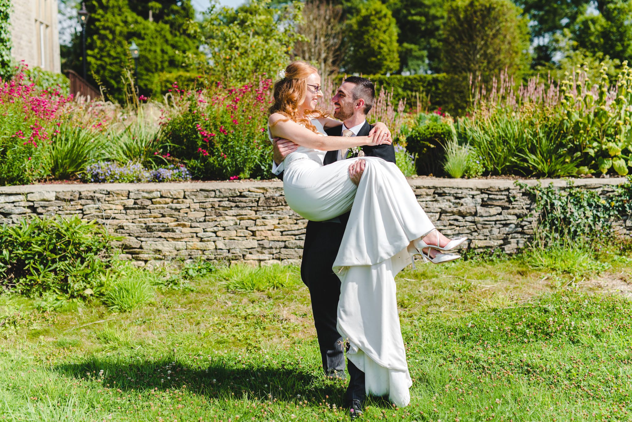 A groom carrying his bride