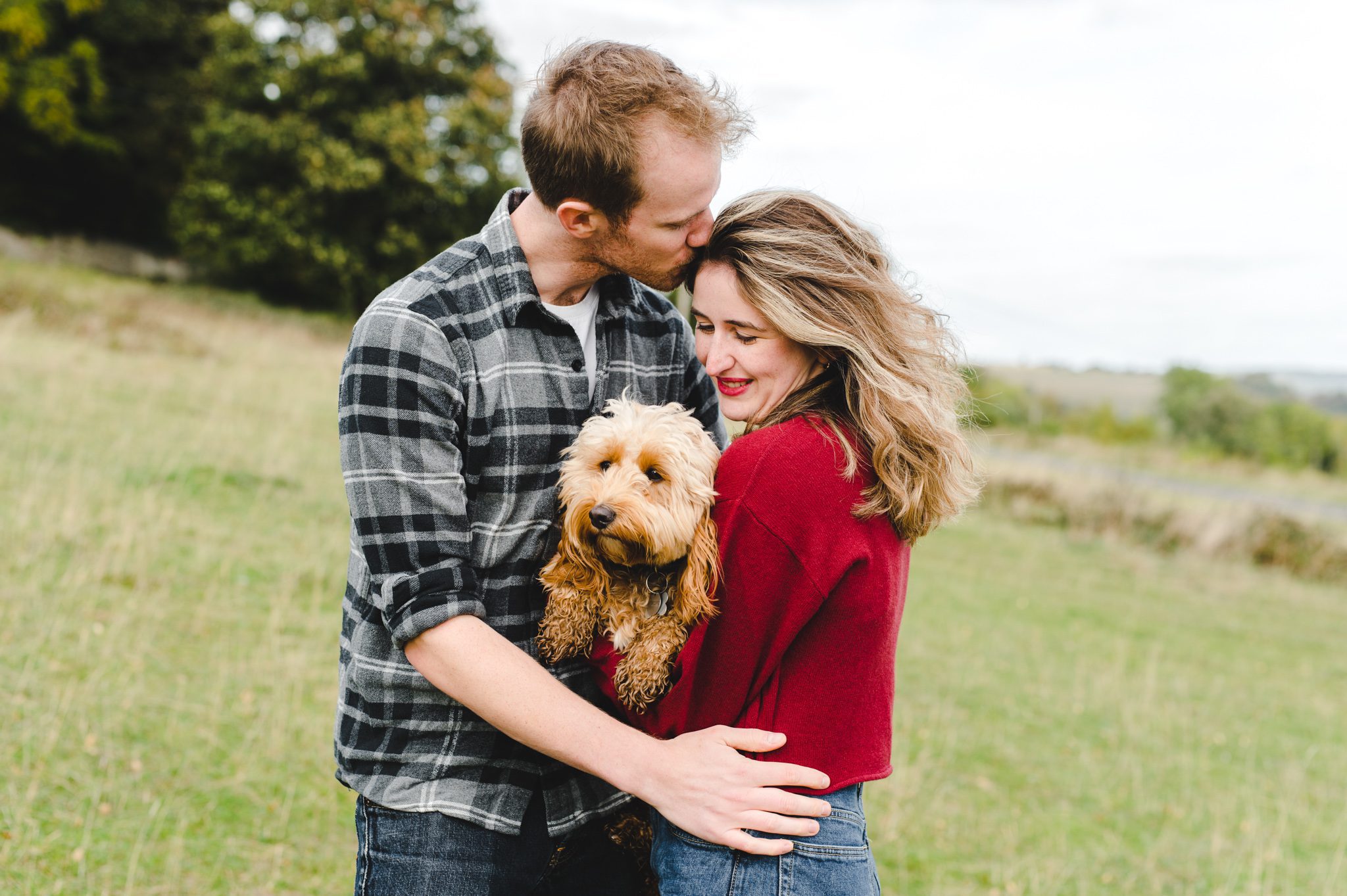 An engaged couple and their dog