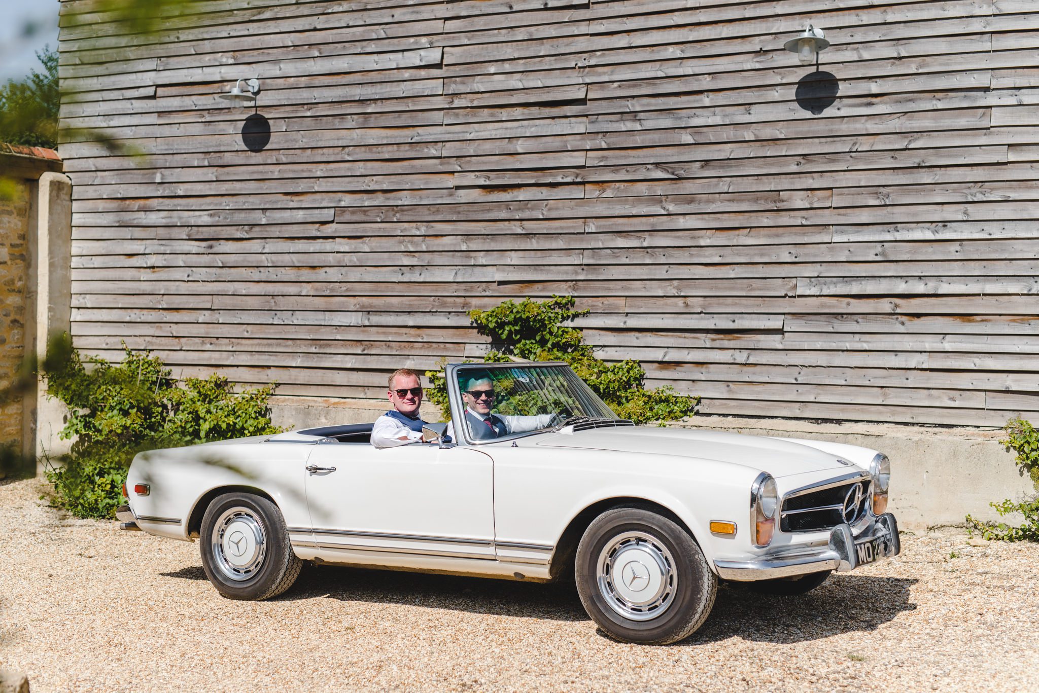 Groom in a drop top Mercedes