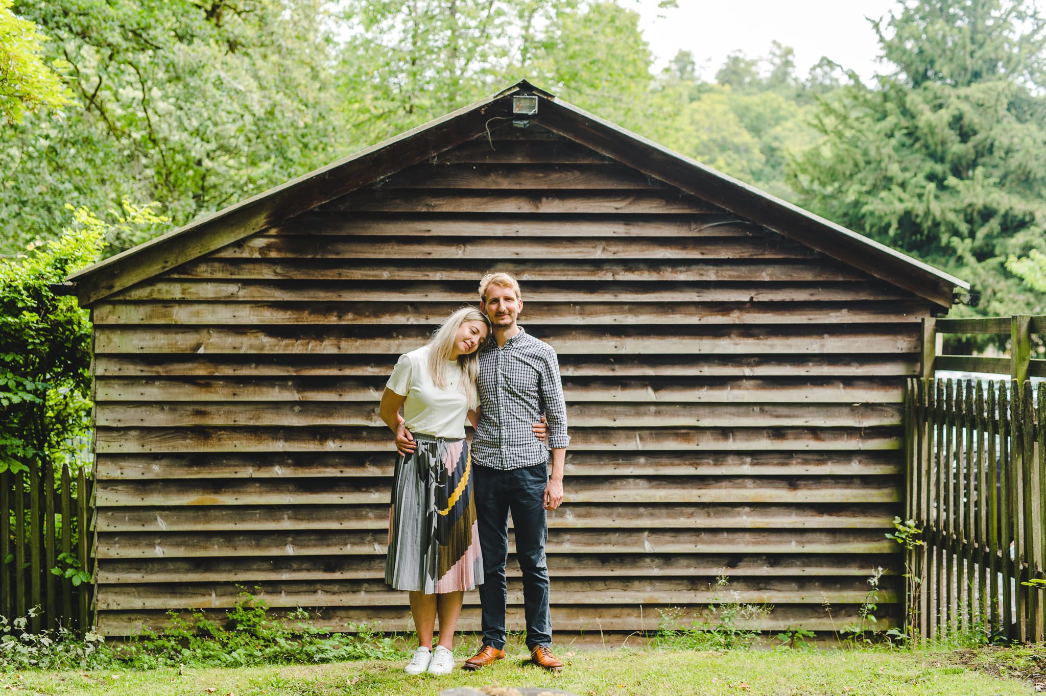 A couple standing by a shed
