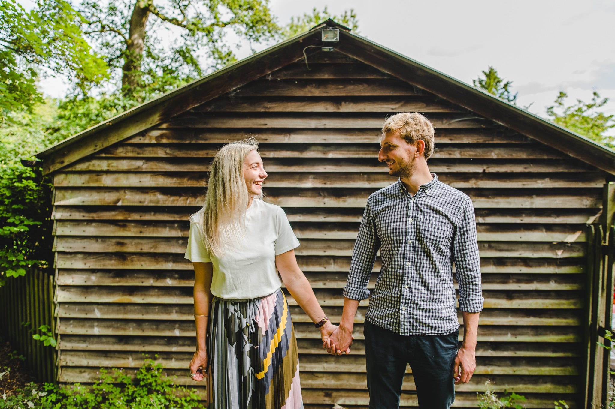 A couple standing by a shed