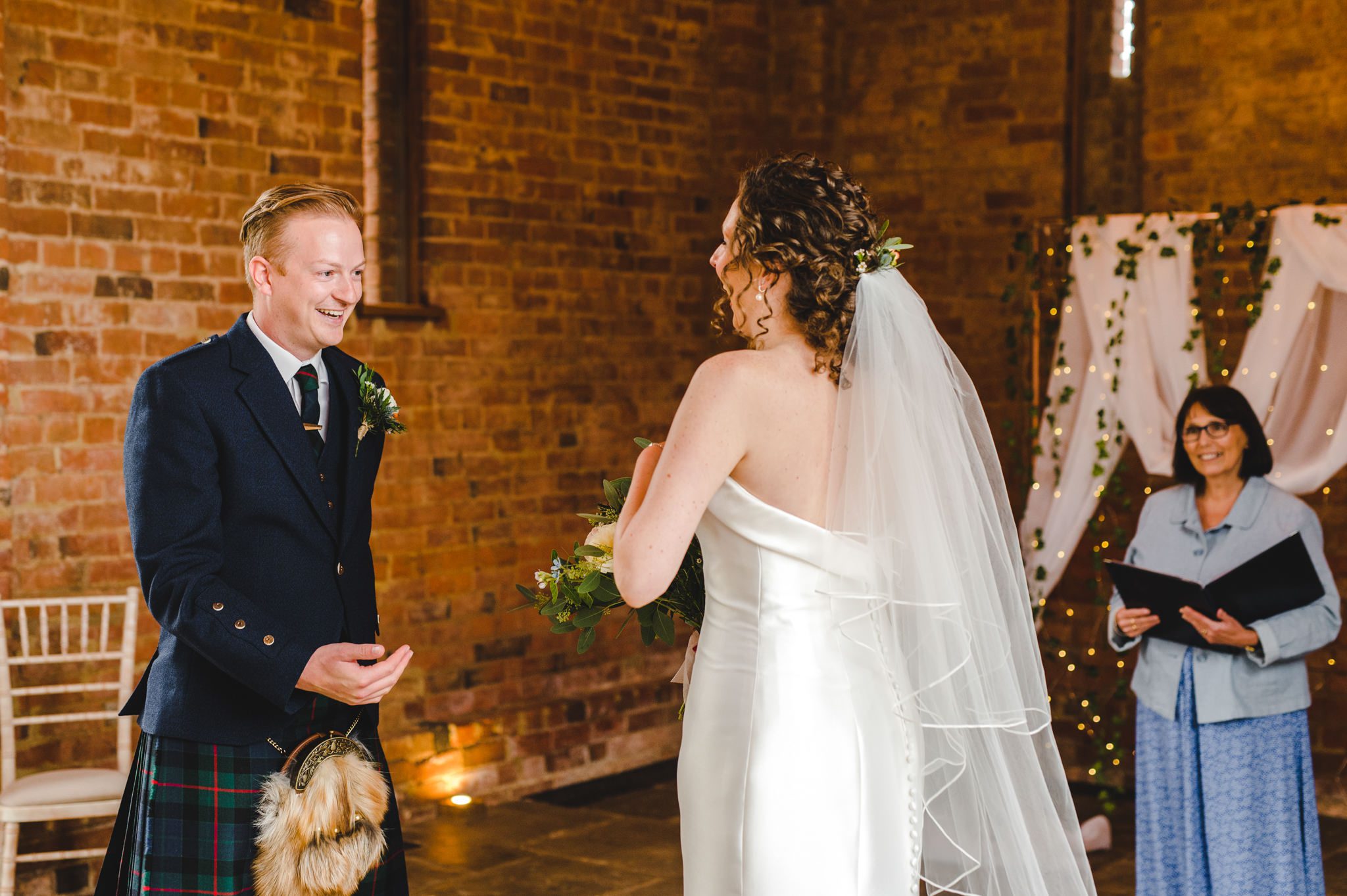 Groom seeing bride in her wedding dress for the first time.