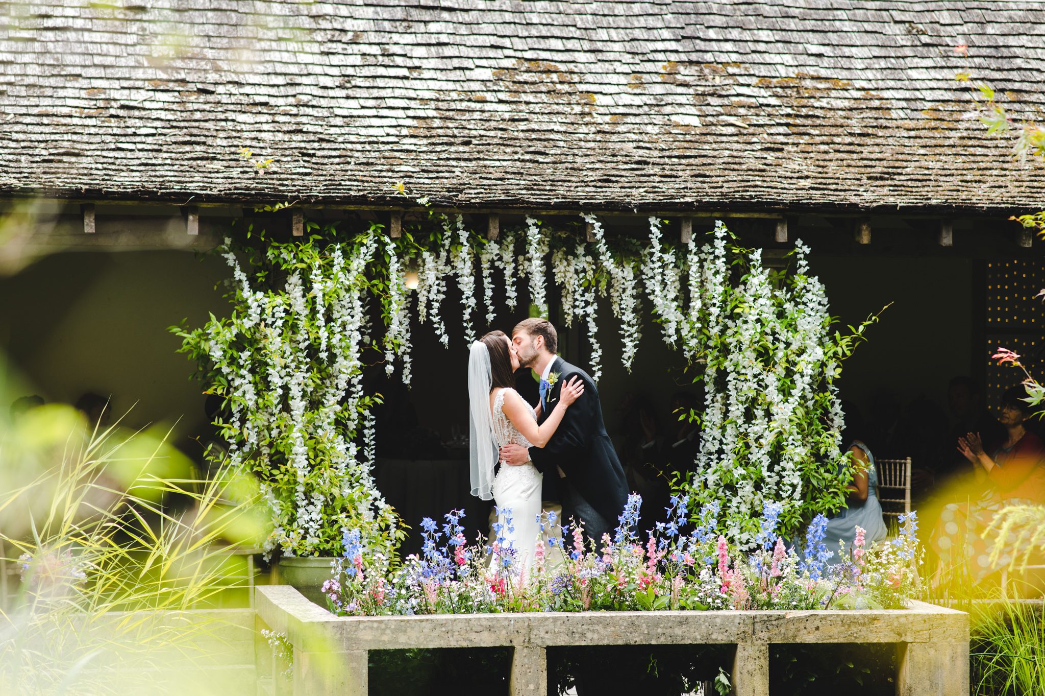 First kiss in the cloisters at Matara outdoor wedding ceremony