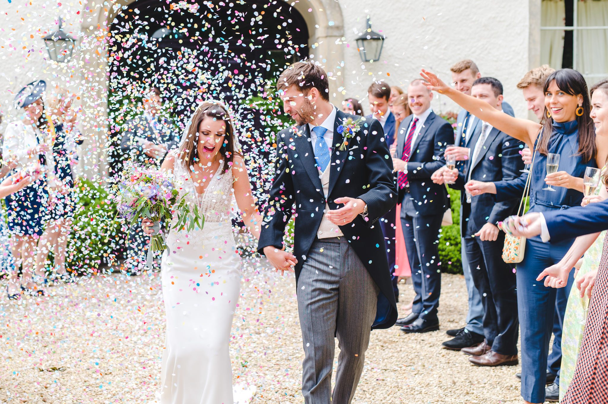 bride and groom covered in confetti
