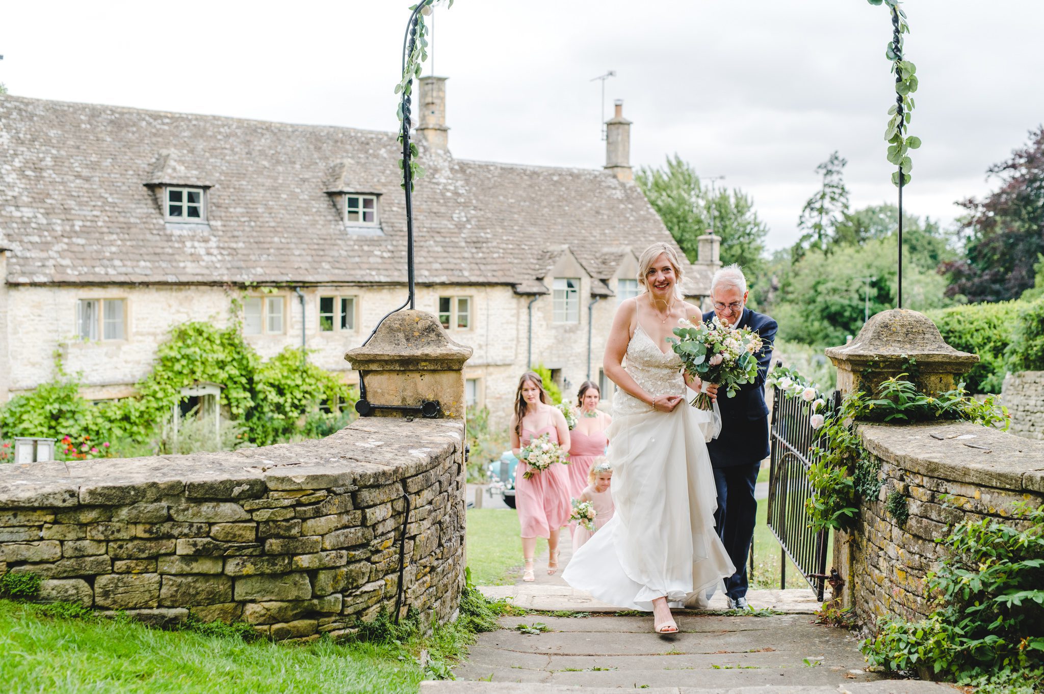 A bride walking to Chedworth Church