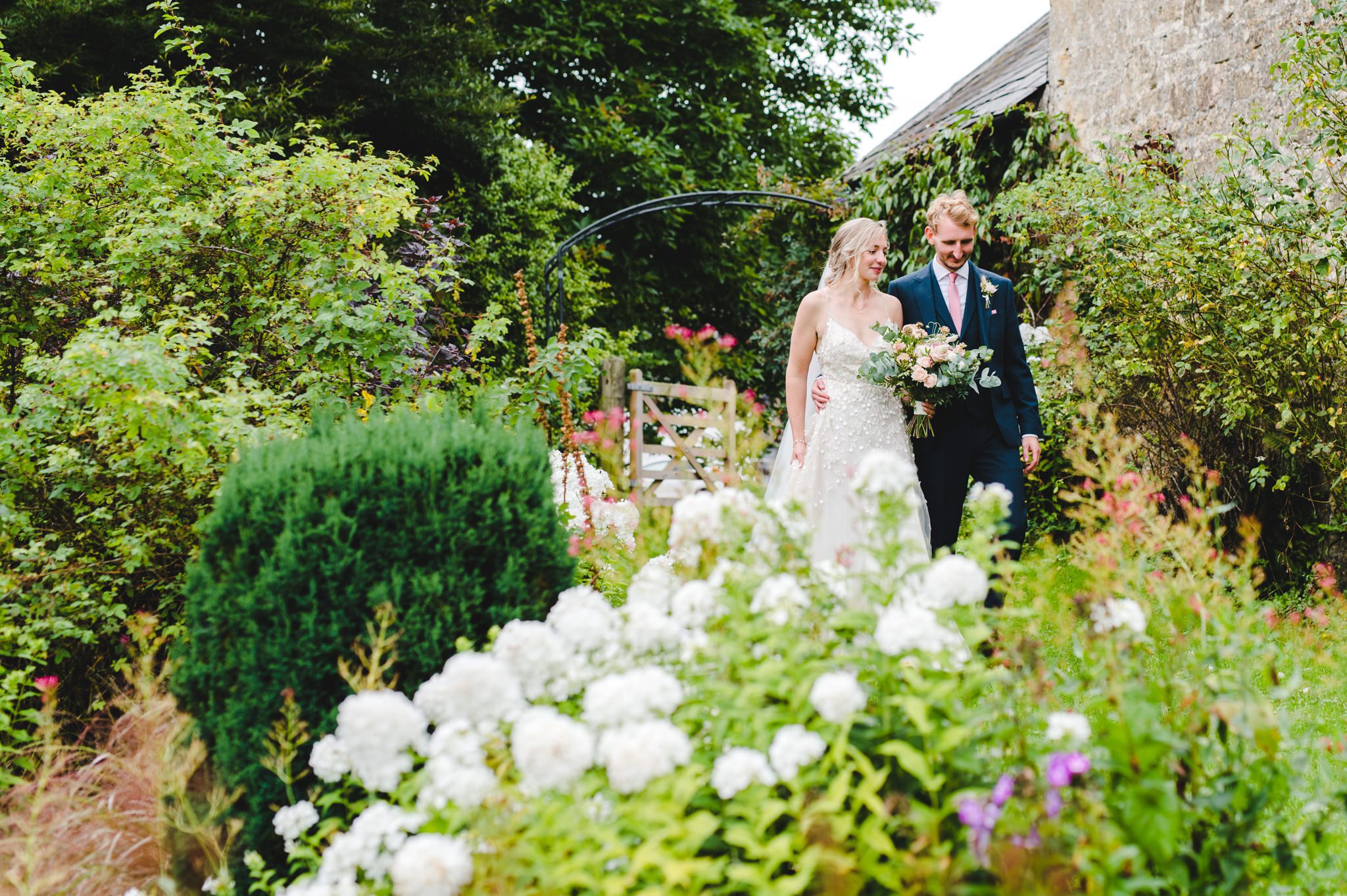 A bride and groom in upcote barn gardens