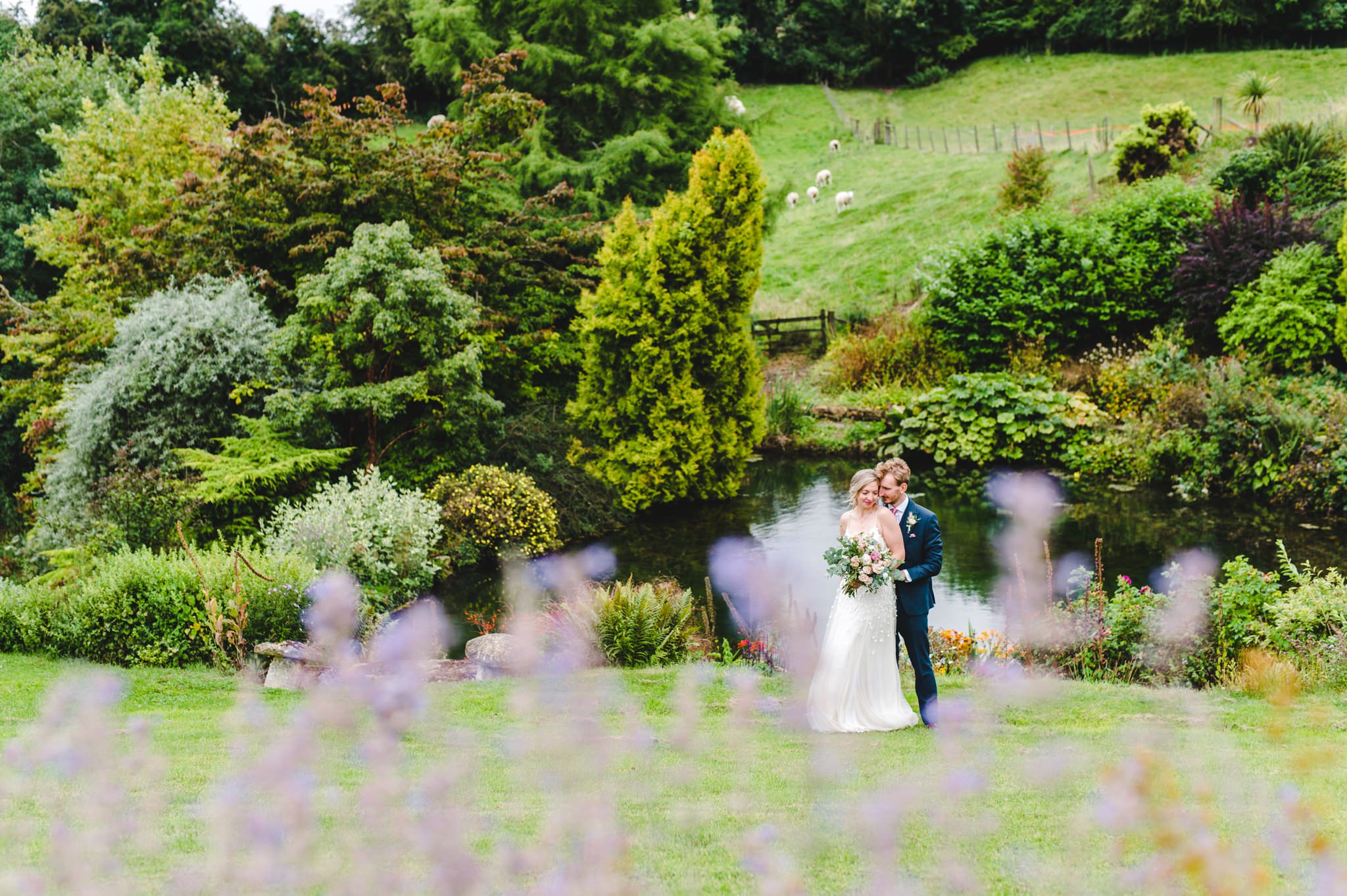 Bride and groom pictures by the lake at Upcote Barn