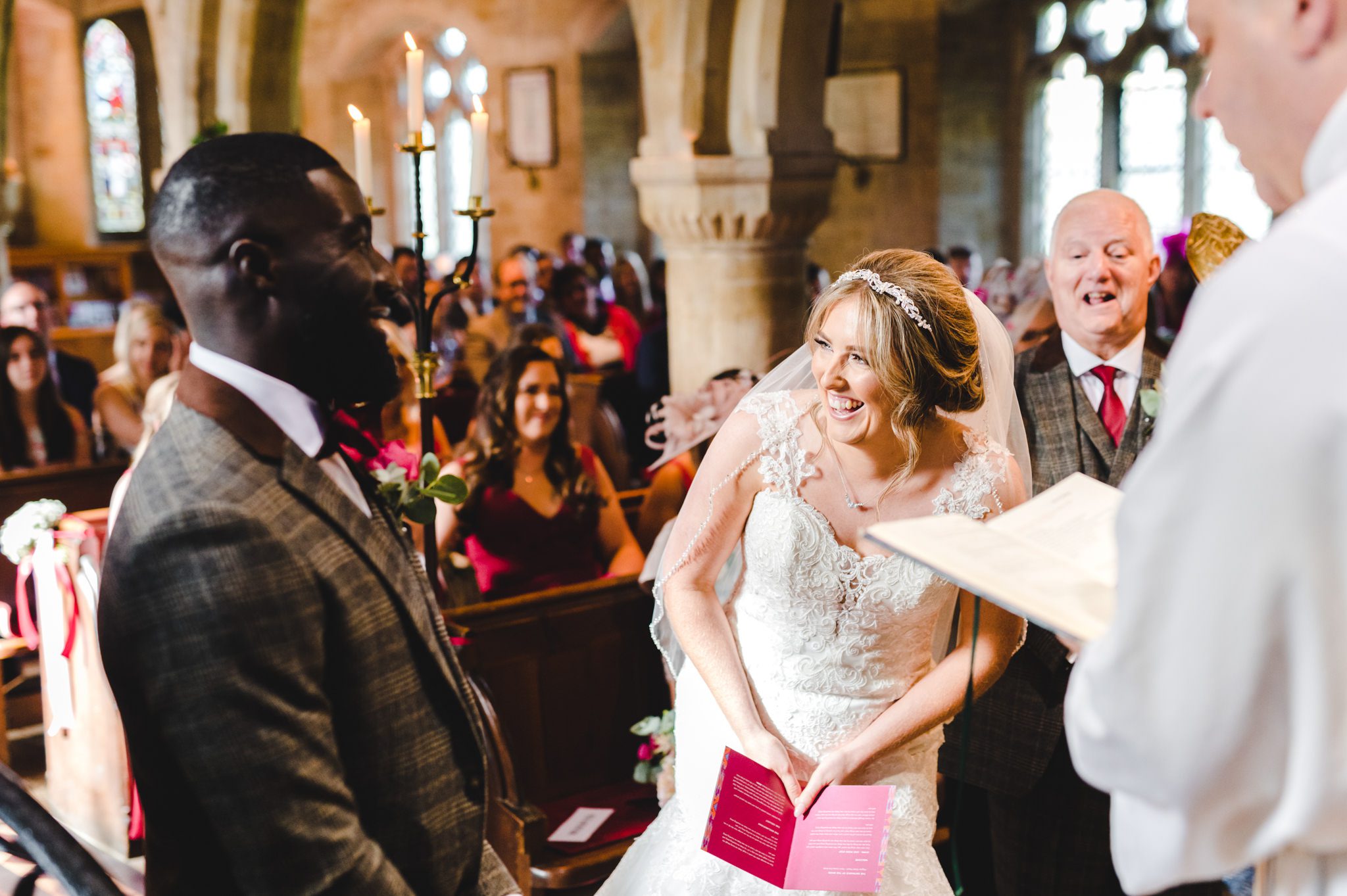 A bride laughing during the church ceremony