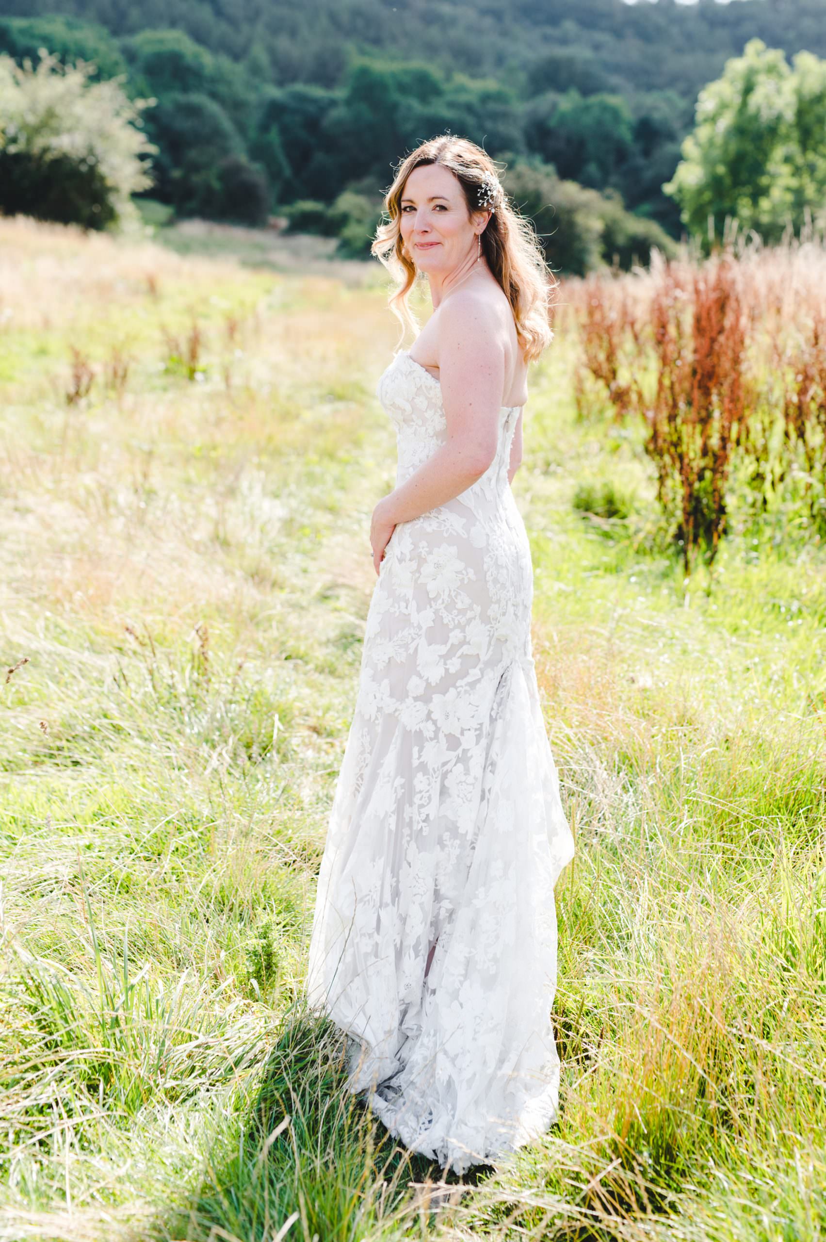 A bride on a hill in Cheltenham in her wedding dress