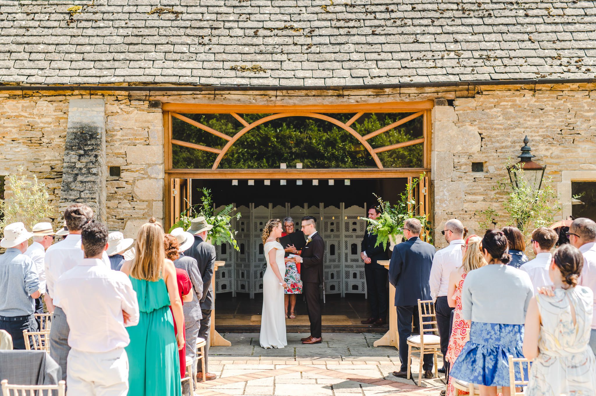An outdoor wedding ceremony at Oxleaze Barn