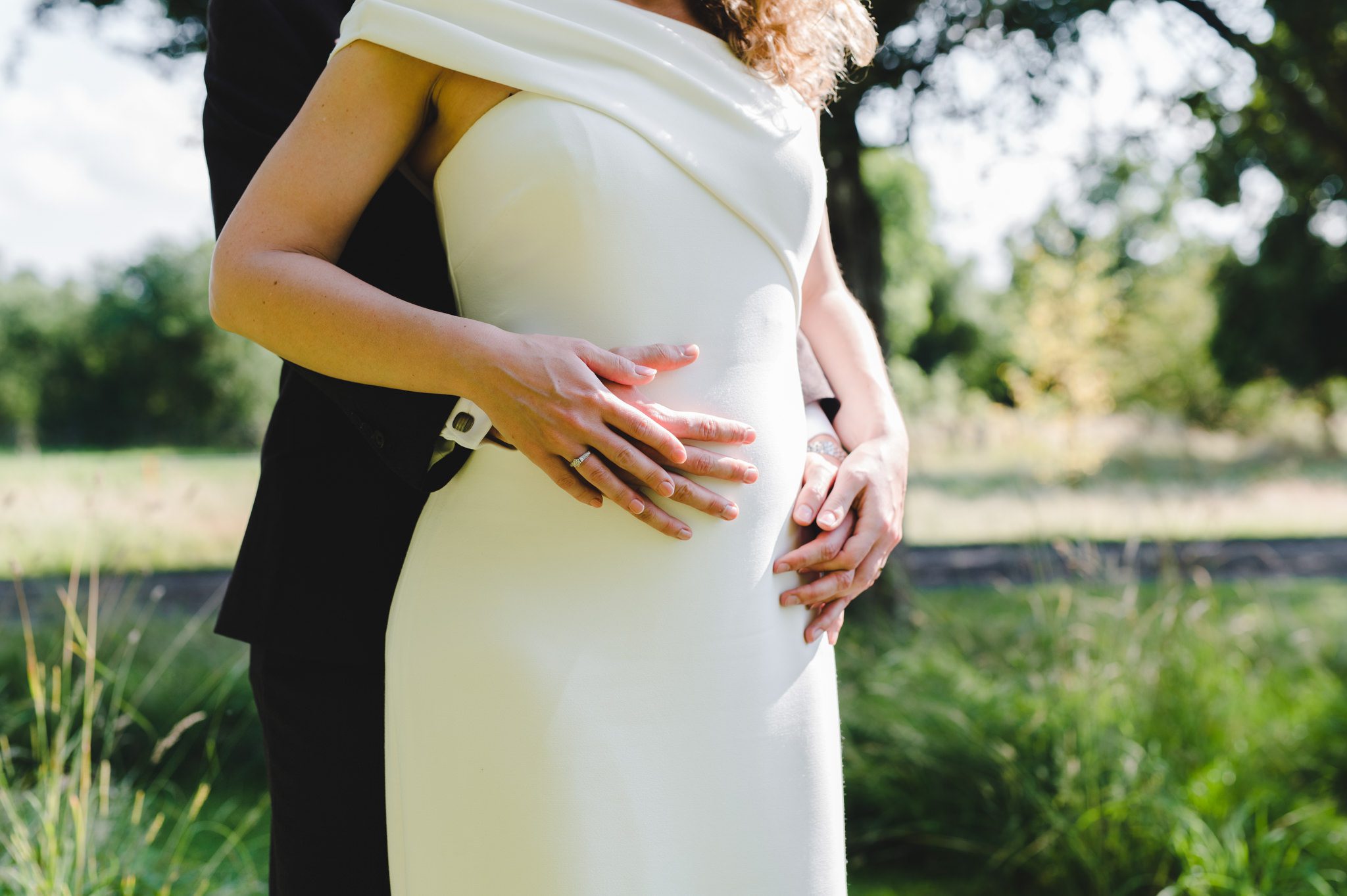 A pregnant bride with her groom