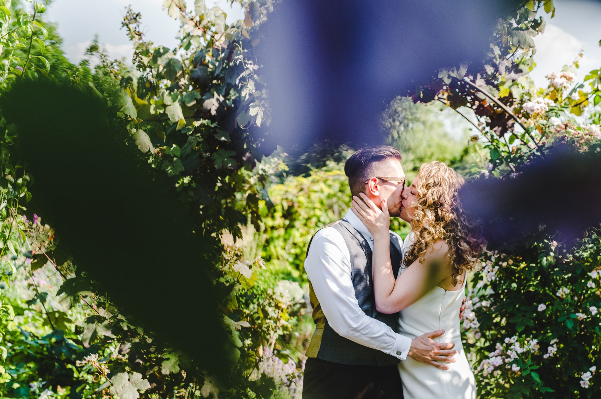 A couple having a close moment at Oxleaze Barn in Gloucestershire