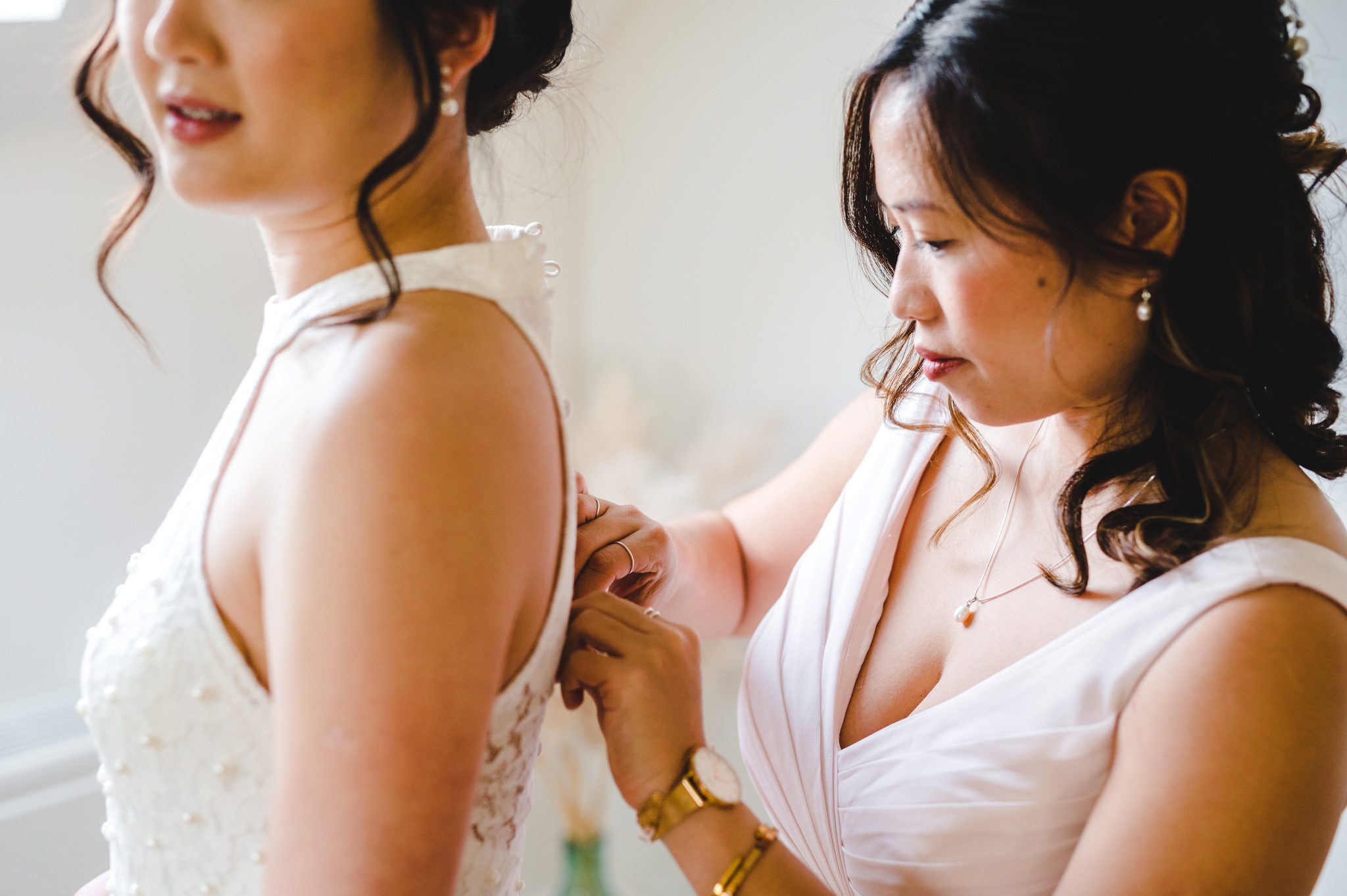 Bride's dress being fastened