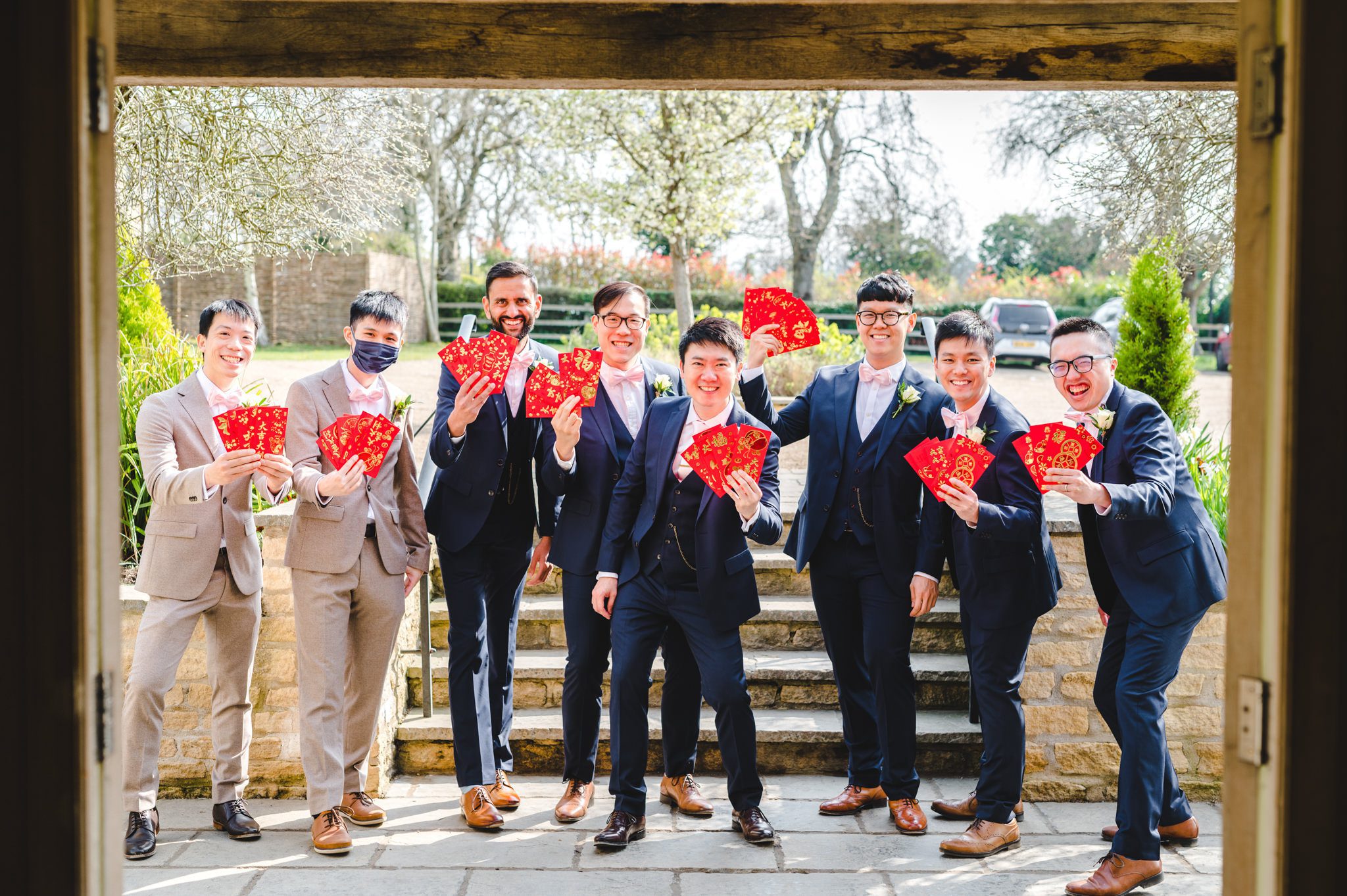 Groomsmen with red envelopes