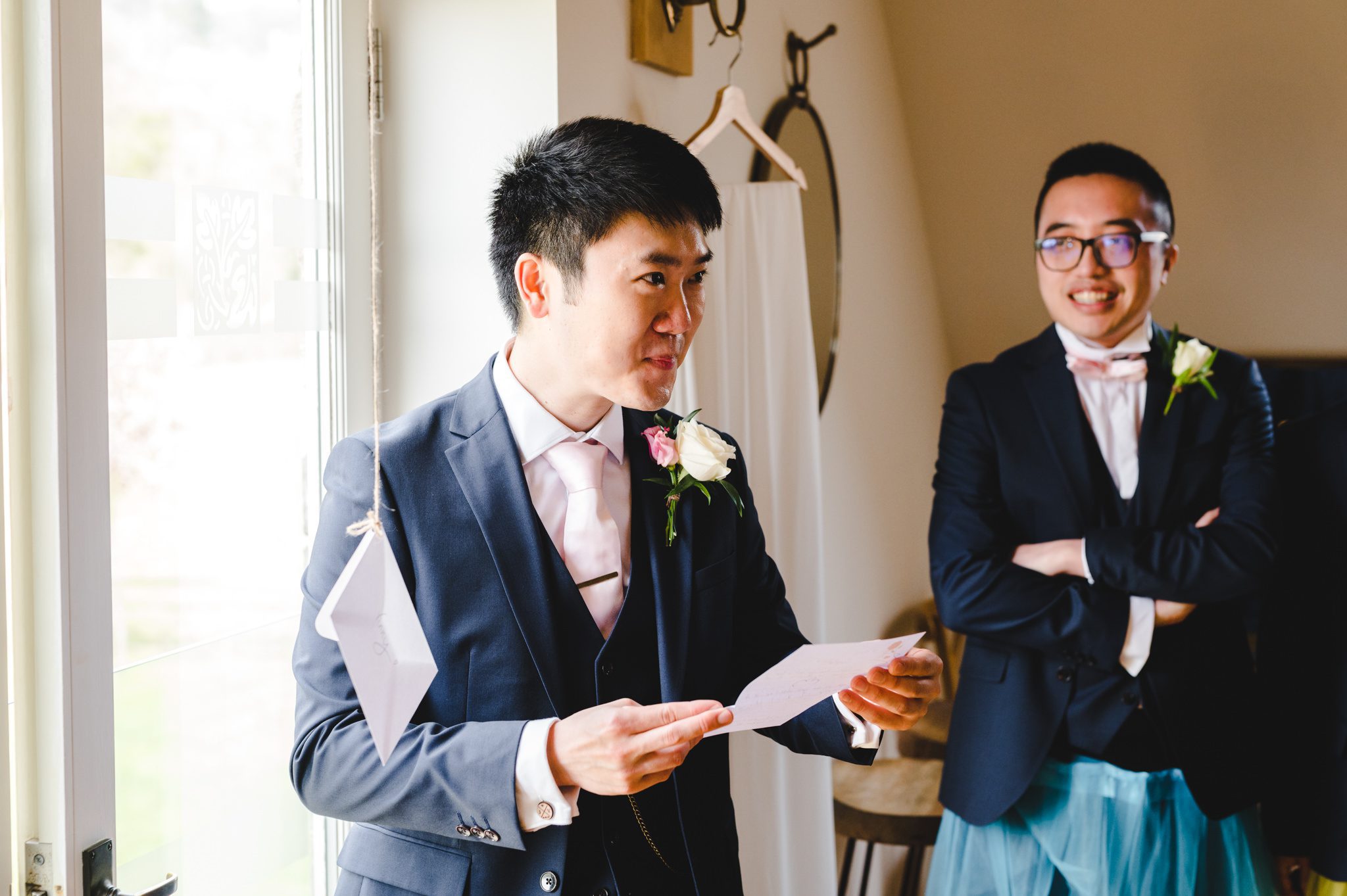 A groom being emotional reading a letter from his bride