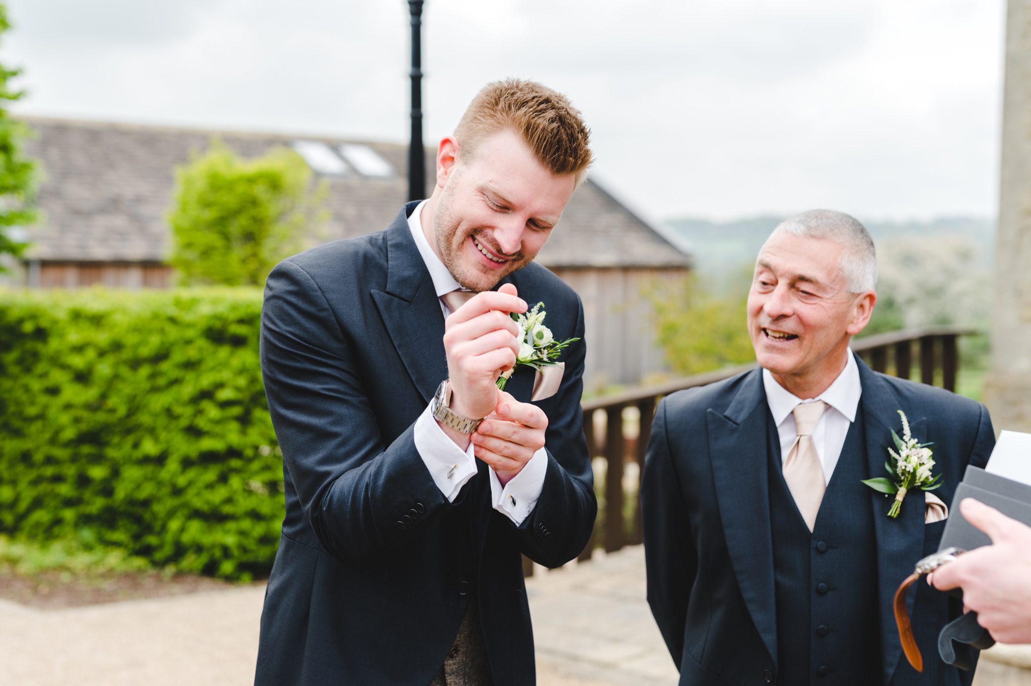 A groom putting on a watch as a gift from his bride