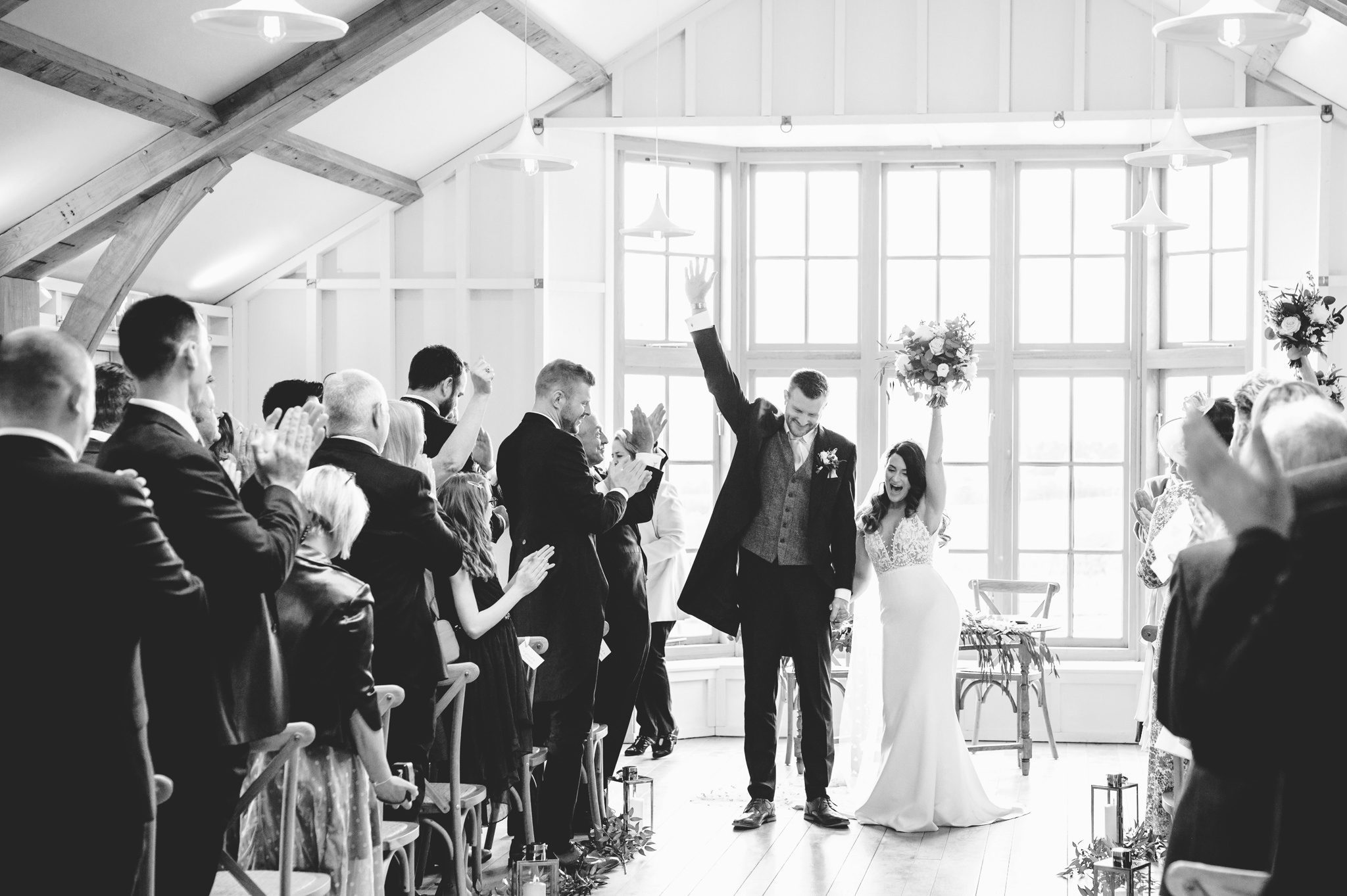 bride and groom walking back down the aisle in The Grange at Hyde House