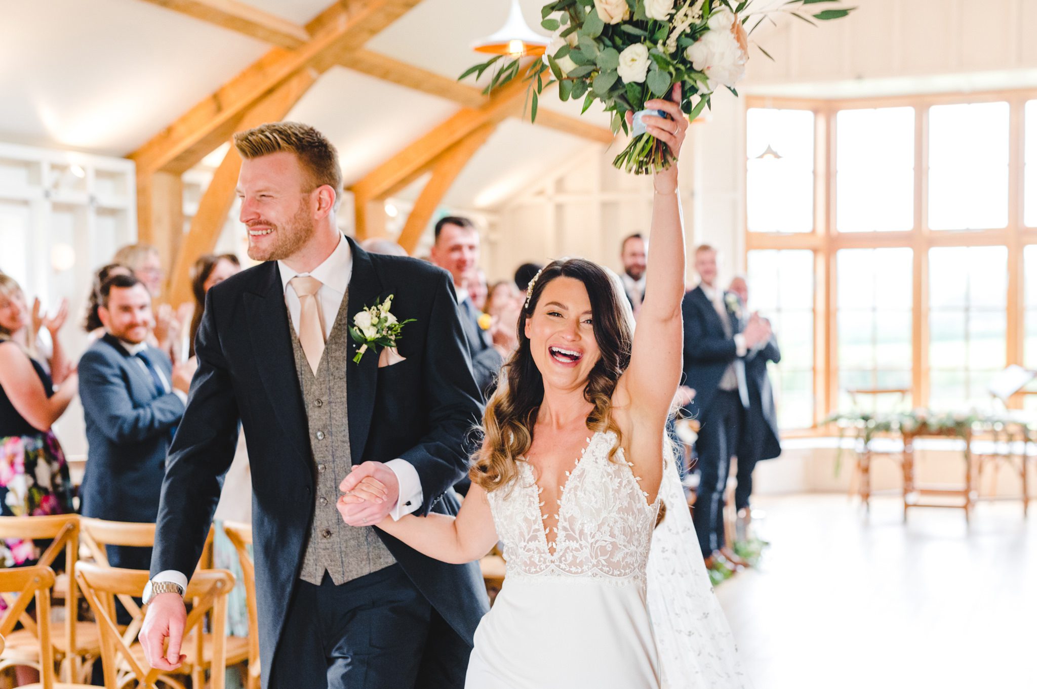 bride and groom walking back down the aisle in The Grange at Hyde House