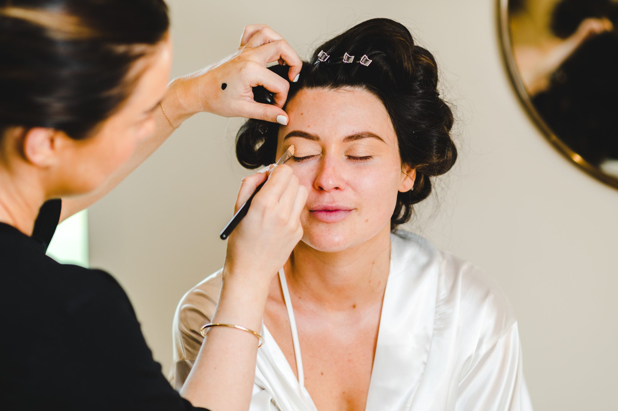 A bride having her make-up applied at hyde house