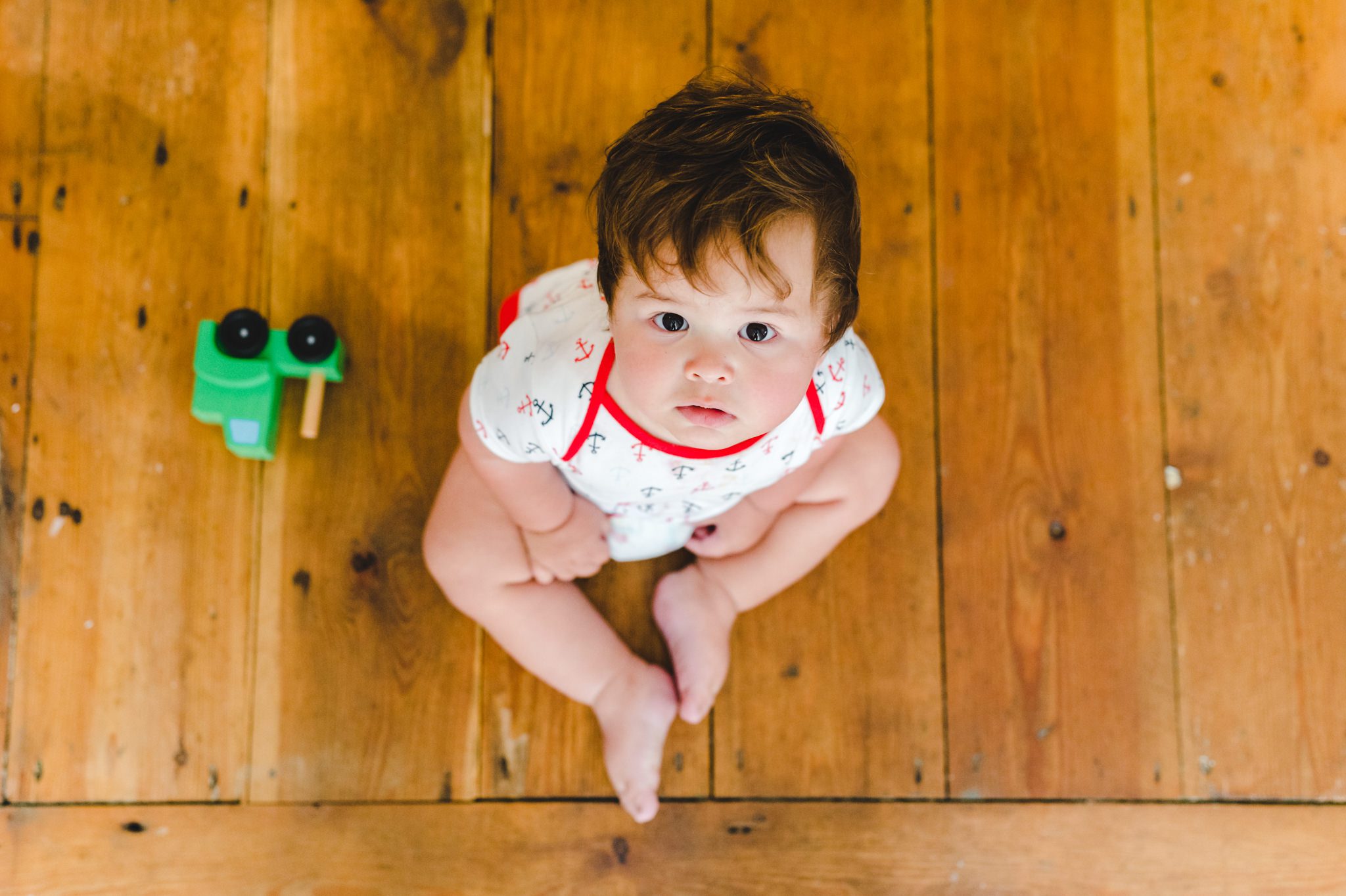 A little boy looking up at the camera