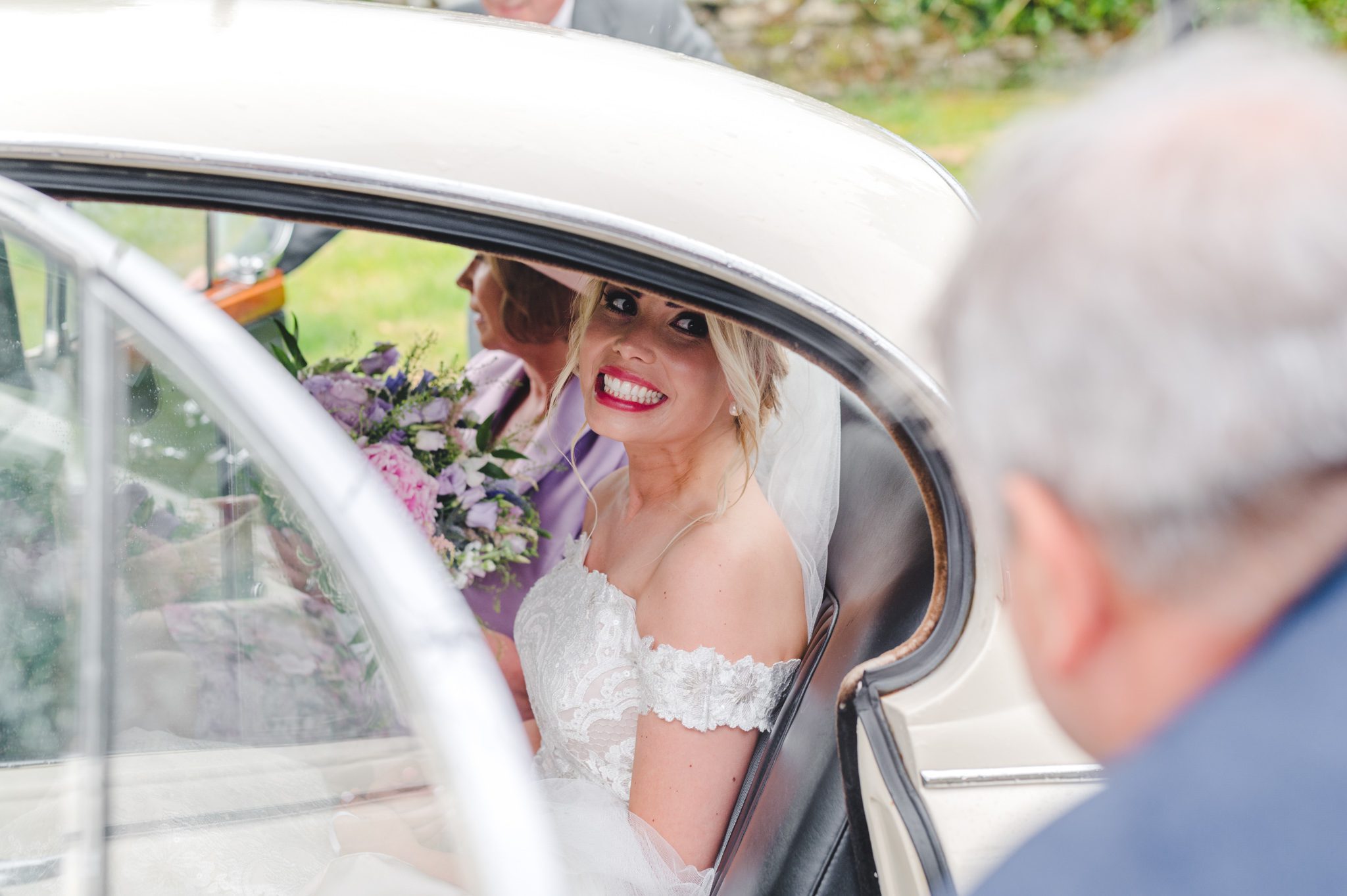 A bride getting out of her car ahead of her wedding ceremony