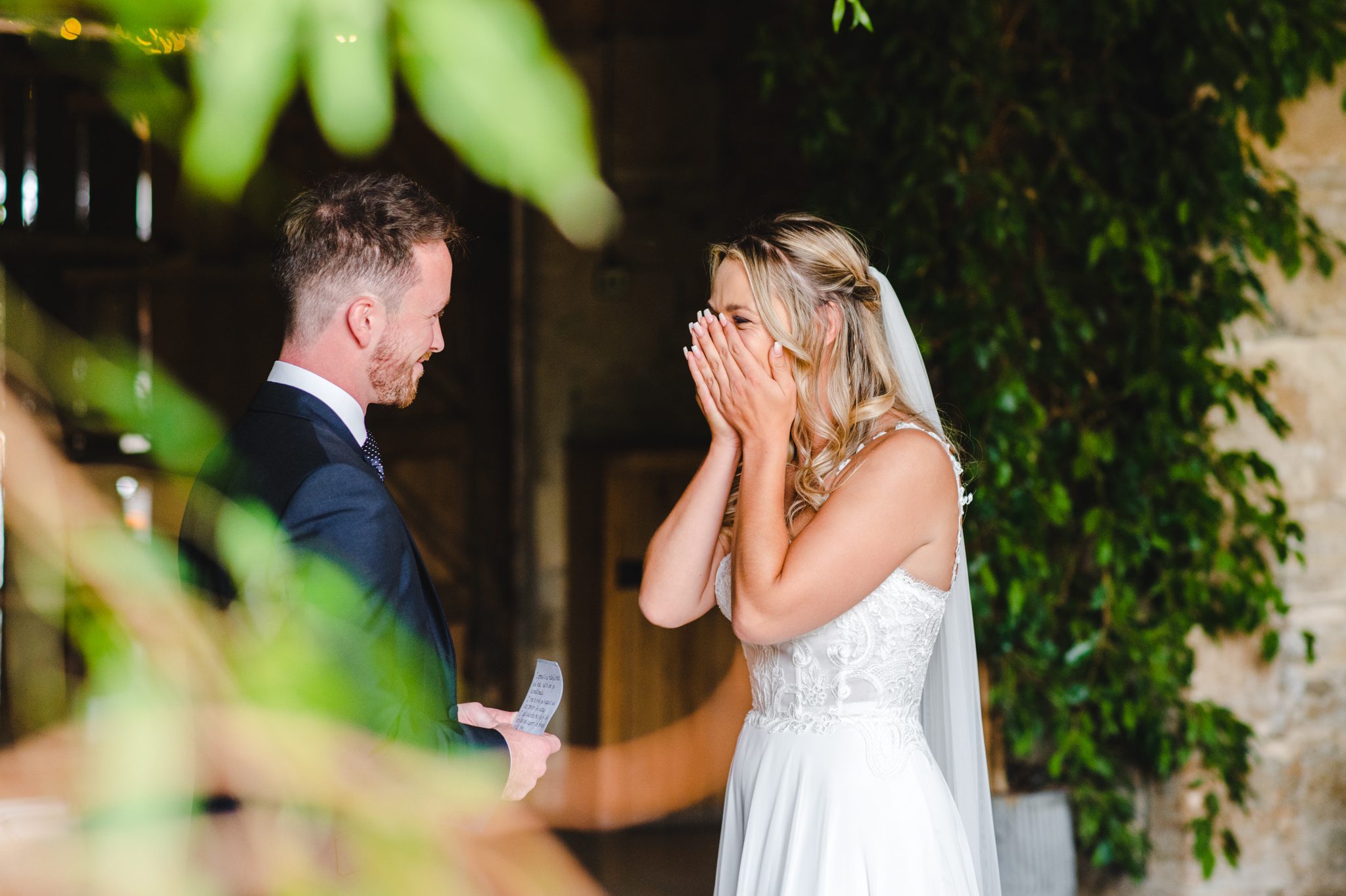 A bride crying at her grooms words during the ceremony at Stone Barn