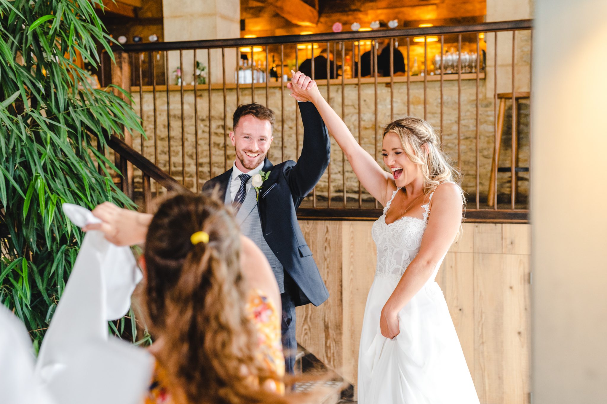 Bride and groom walking into their wedding breakfast